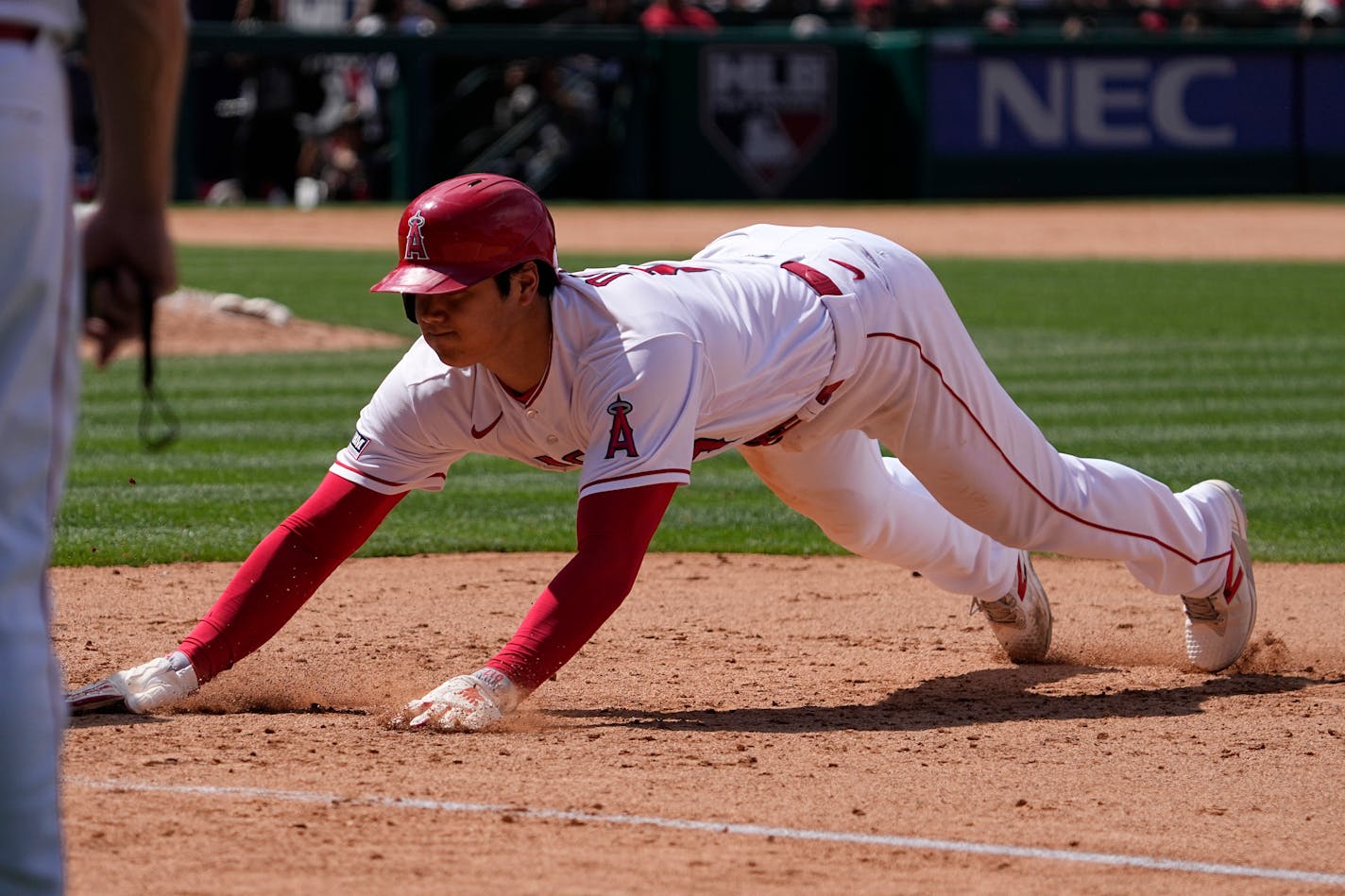 Los Angeles Angels' Shohei Ohtani dives back to first during the seventh inning of a baseball game against the Minnesota Twins Sunday, May 21, 2023, in Anaheim, Calif. (AP Photo/Mark J. Terrill)