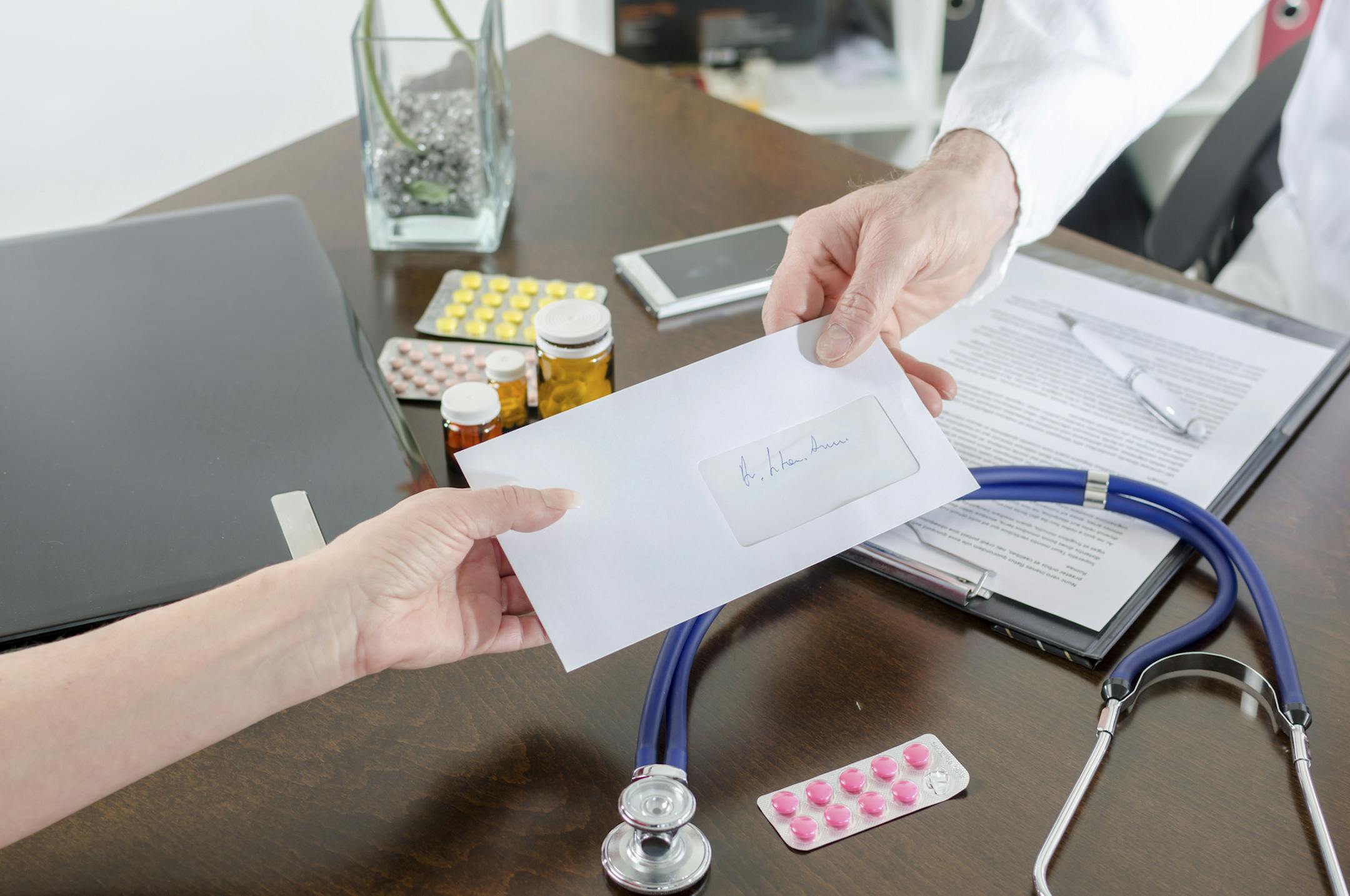 Doctor giving a prescription to his patient in medical office. istock photo