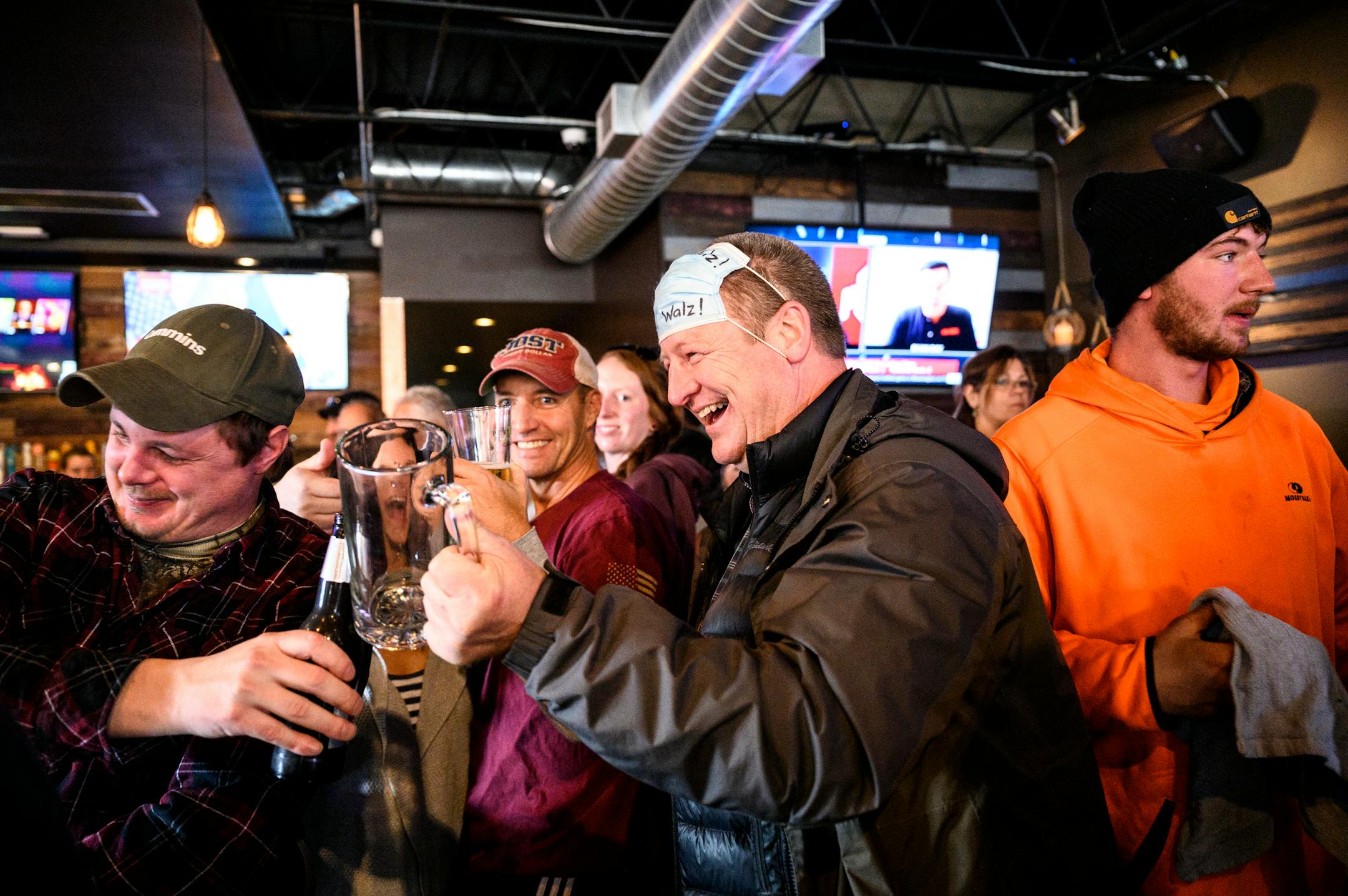 Dean Wedul, of Lakeville, right of center, lifted his drink with friends at the bar at Alibi Drinkery in Lakeville Wednesday.