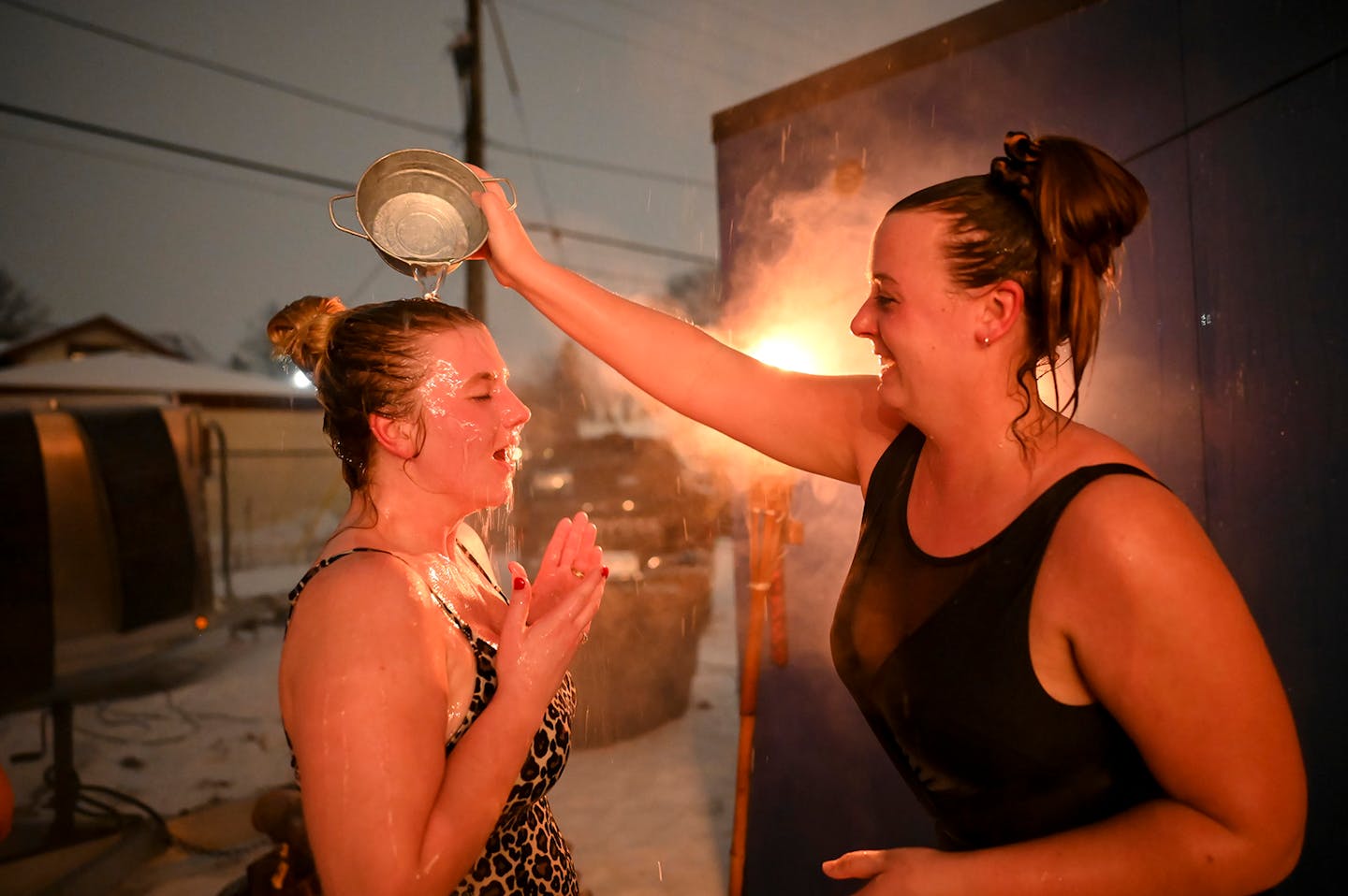 Hannah Peine, of St .Paul, poured water onto the head of her friend, Lindsey Hostetler, of Northfield, after they emerged from a sauna.