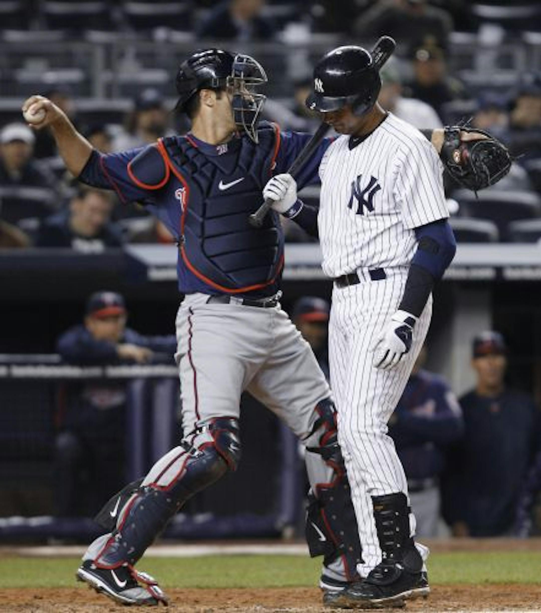 Twins catcher Joe Mauer threw back to the mound as Derek Jeter walked back to the Yankees dugout following a fifth-inning strikeout on Monday night. Mauer is 1-for-11 at the plate this year and winless.