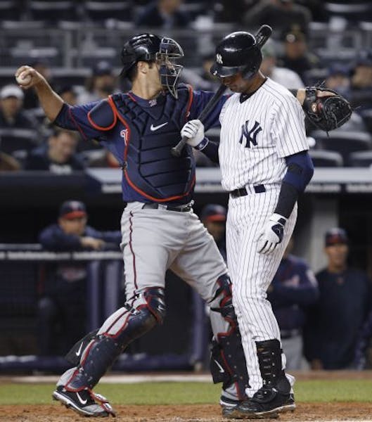 Twins catcher Joe Mauer threw back to the mound as Derek Jeter walked back to the Yankees dugout following a fifth-inning strikeout on Monday night. M