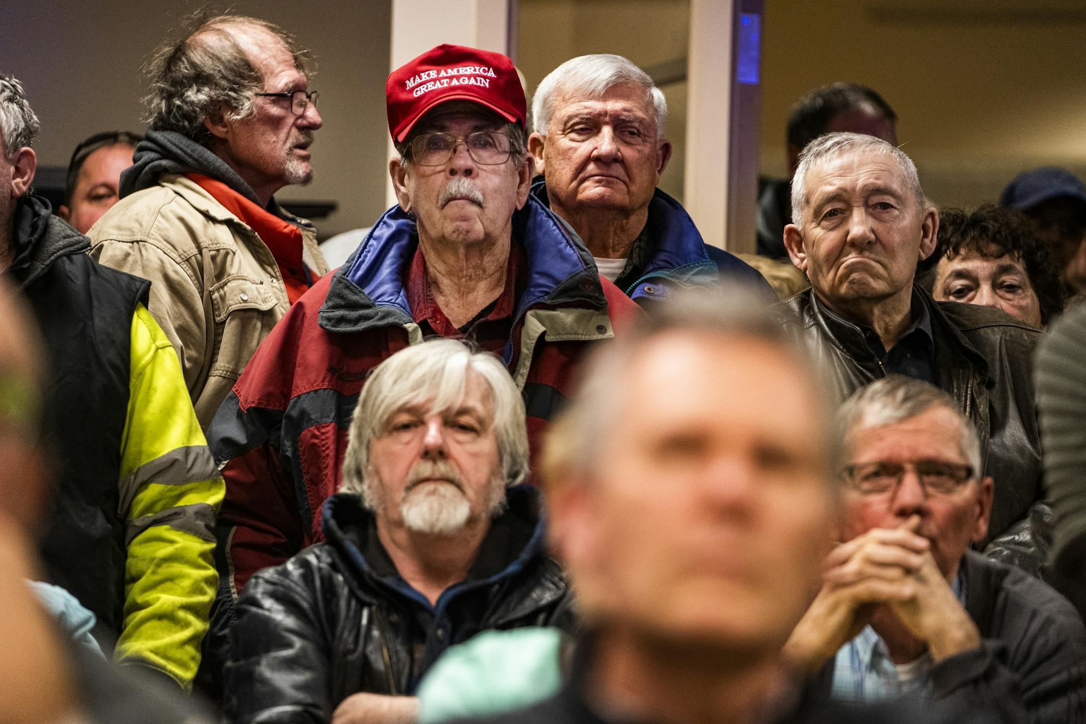 Those in attendance who favored a motion against refugee resettlement stood in the back and made their opinions known.