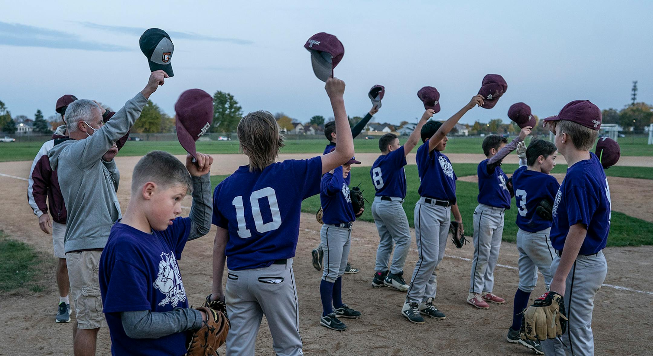 Members of the Bulldogs tipped their hats at the end of the gam during their summer baseball season.