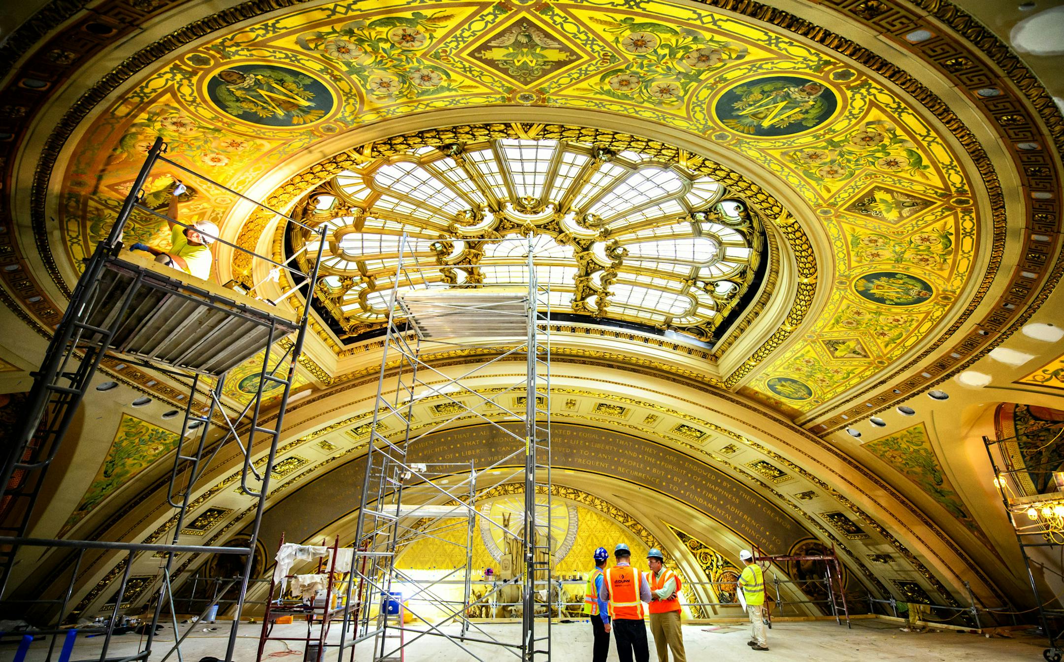 Workers from Conrad Schmitt Studios, a restoration company out of New Berlin, Wisconsin, are painstakingly restoring the murals and gold leaf on the upper level of the Minnesota House Chamber. ] GLEN STUBBE * gstubbe@startribune.com Thursday September 10, 2015