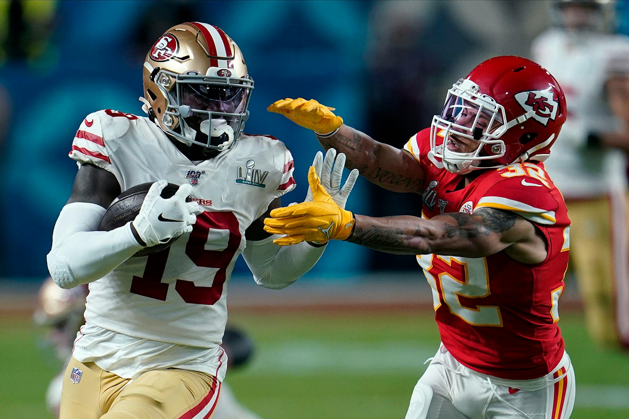 Kansas City Chiefs strong safety Tyrann Mathieu, right, reaches to tackle San Francisco 49ers wide receiver Deebo Samuel during the first half of the NFL Super Bowl 54 football game Sunday, Feb. 2, 2020, in Miami Gardens, Fla.