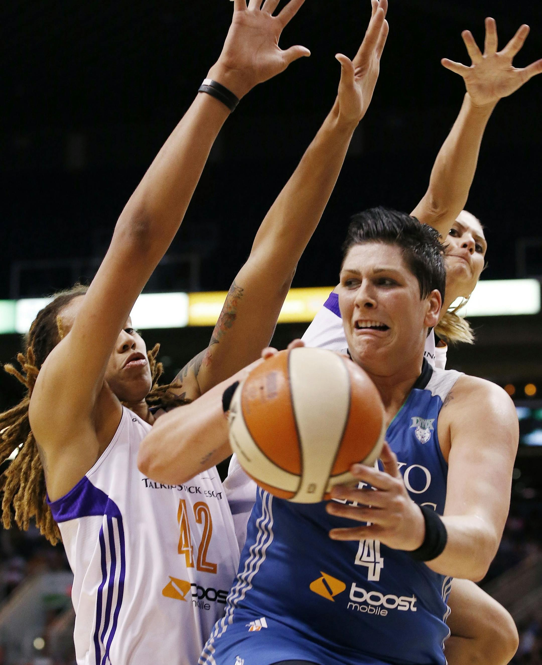 Minnesota Lynx's Janel McCarville, right, tries to get off a pass as Phoenix Mercury's Brittney Griner (42) and Penny Taylor, of Australia, defend during the first half of Game 3 in the WNBA Western Conference basketball finals Tuesday, Sept. 2, 2014, in Phoenix. (AP Photo/Ross D. Franklin)