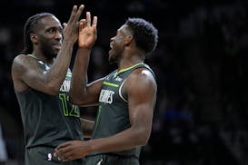 Minnesota Timberwolves forward Taurean Prince, left, and guard Anthony Edwards celebrate during the second half of an NBA basketball game against the 