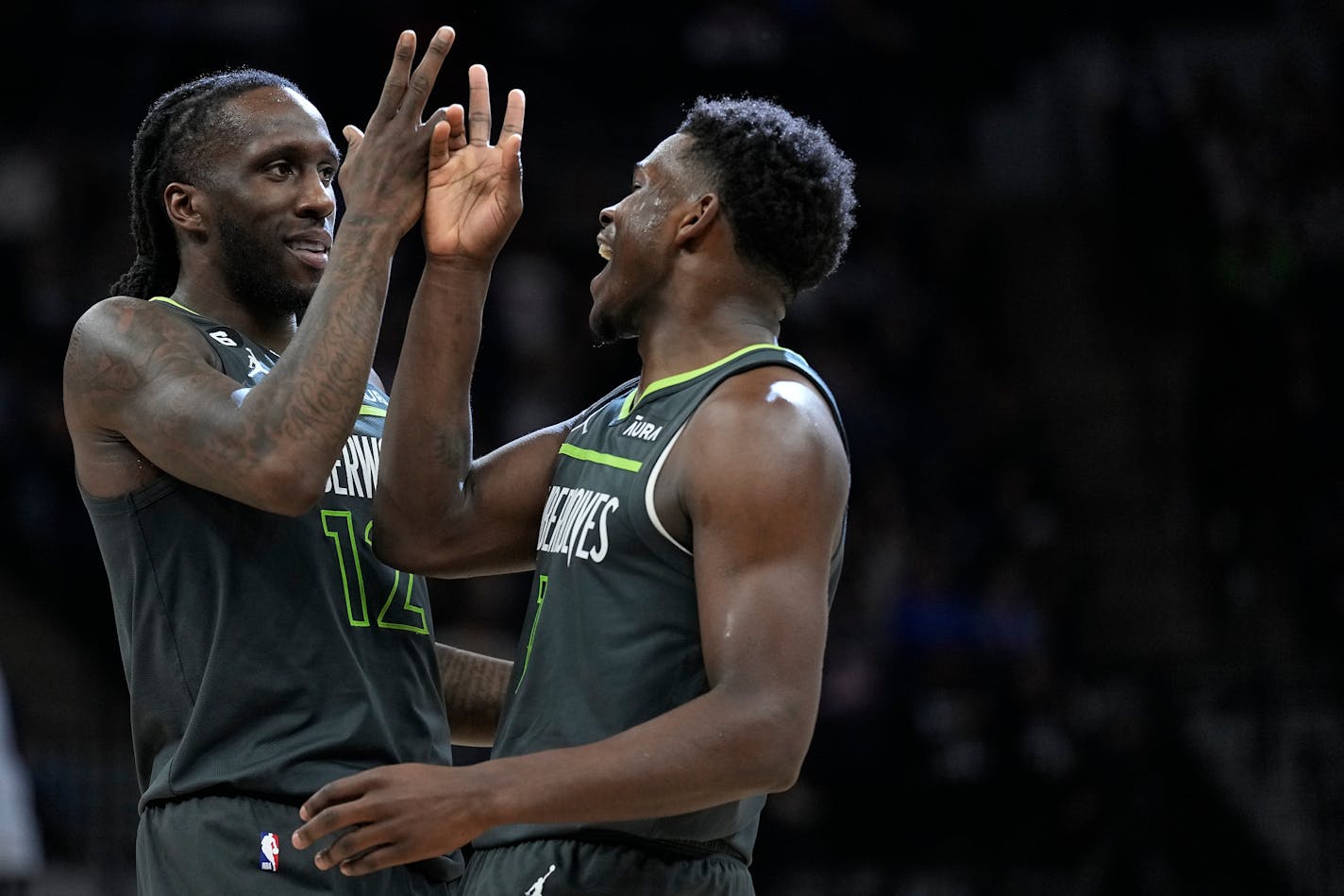 Minnesota Timberwolves forward Taurean Prince, left, and guard Anthony Edwards celebrate during the second half of an NBA basketball game against the Houston Rockets, Saturday, Jan. 21, 2023, in Minneapolis. (AP Photo/Abbie Parr)