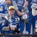 Jimmie Johnson sprayed sparking wine as he celebrated in Victory Lane after he won the NASCAR Sprint Cup series auto race at Dover International Speed