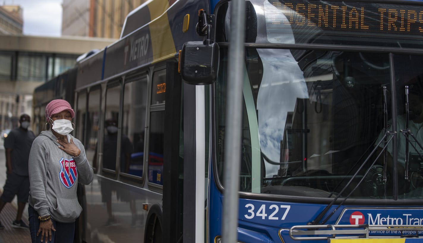 Ebony Yeshua waited to board a METRO bus at 8th Street and Nicollet Avenue on Monday morning .] Jerry Holt •Jerry.Holt@startribune.com Face coverings will be required on board all Metro Transit buses and trains Monday May 18, 2020 in Minneapolis , MN.