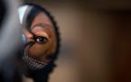 Dynasty Born Asia watched through a mirror as makeup artist Morayo Allibalogun worked on her face during the Kings and Queens Day event at YouthLink, 