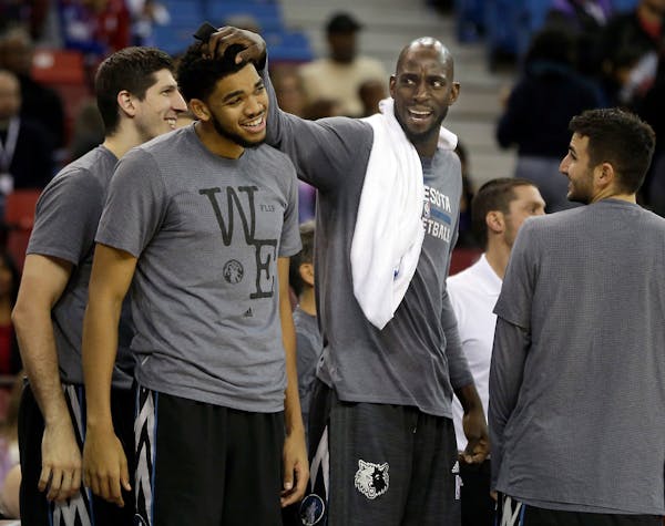 Veteran Timberwolves forward Kevin Garnett, second from right, has served more as a mentor to youngsters like Karl-Antony Towns than as a player this 