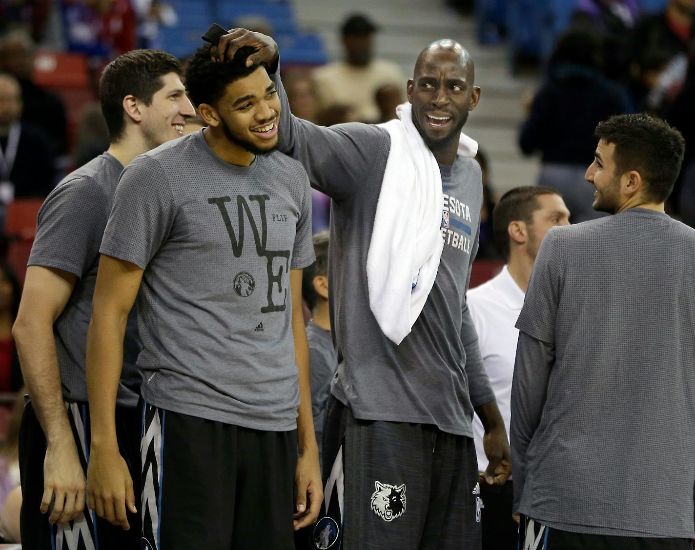 Veteran Timberwolves forward Kevin Garnett, second from right, has served more as a mentor to youngsters like Karl-Antony Towns than as a player this season.