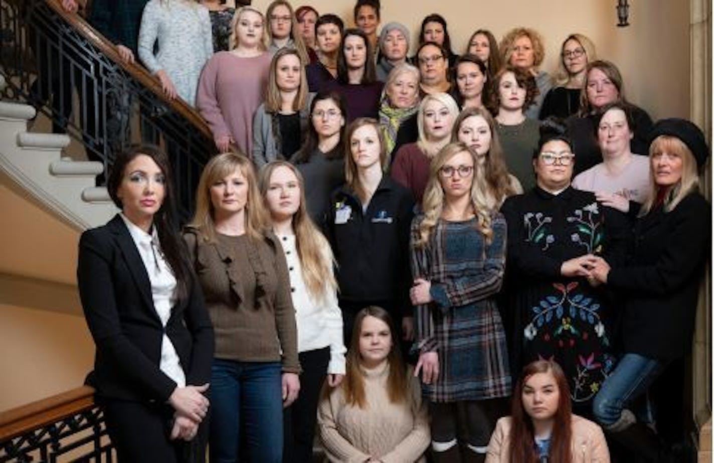 Women who were victims of sexual assault pose for a photo together at the state Capitol in St. Paul in December.