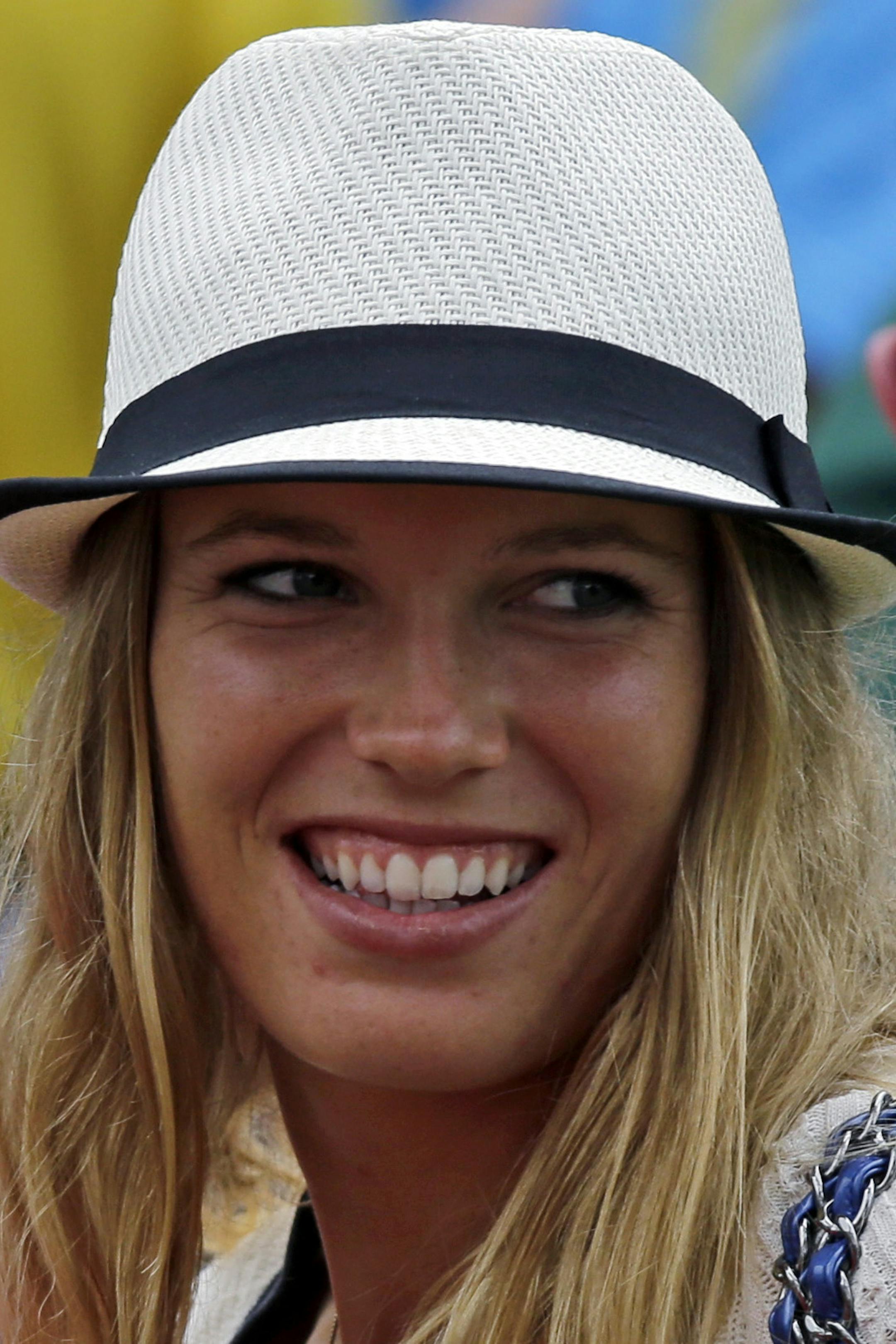 Tennis player Caroline Wozniacki speaks with Northern Ireland's Rory McIlroy's father Gerry McIlrory during the first round of the Masters golf tournament Thursday, April 11, 2013, in Augusta, Ga. (AP Photo/David J. Phillip)
