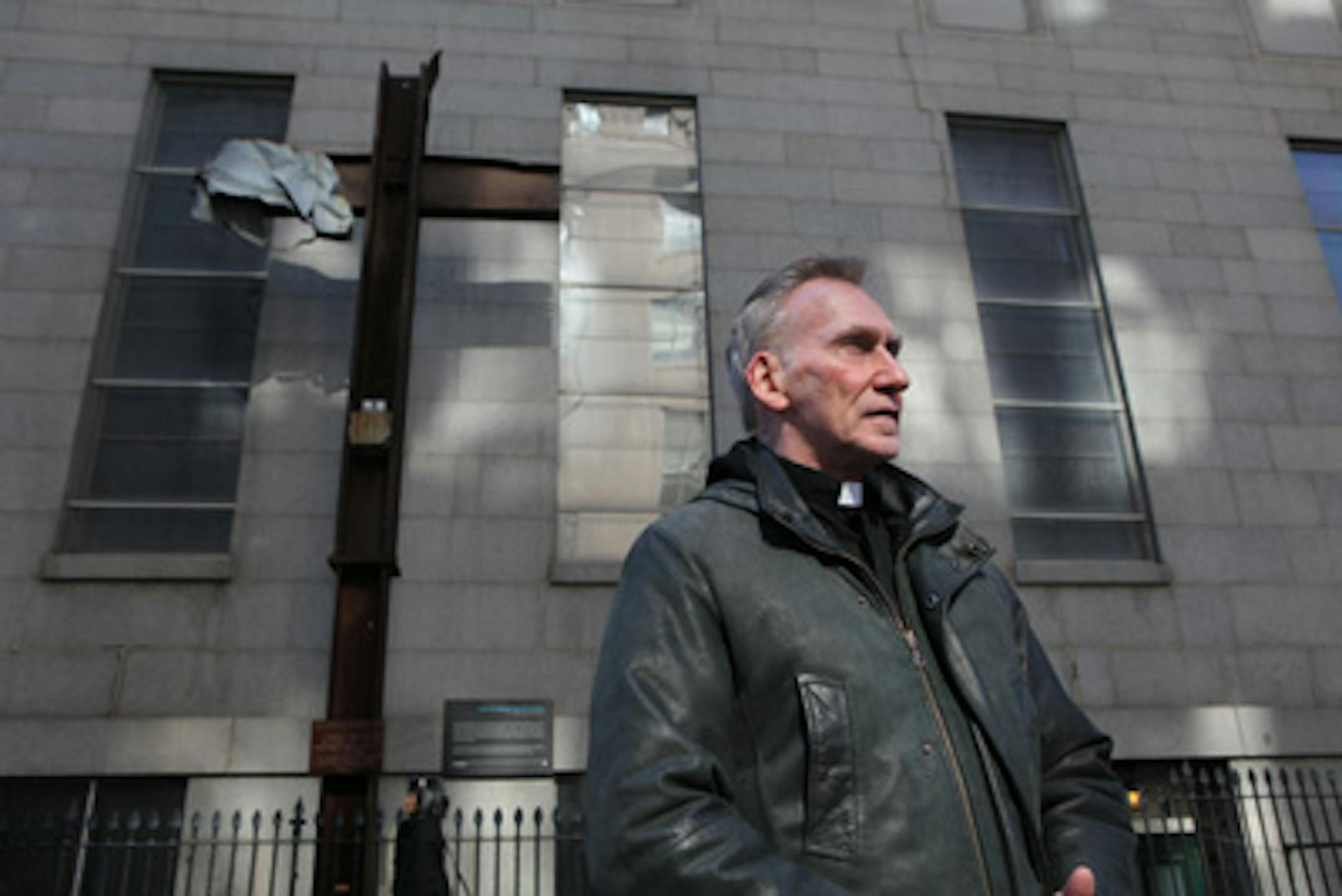 (RNS1-APR06) A cross formed from a falliing steel I-beam at the former World Trade Center towers was placed outside St. Peter's Catholic Church in lower Manhattan where the Rev. Kevin Madigan kept watch over it until its pending move to the National September 11 Memorial & Museum. For use with RNS-GROUNDZERO-CROSS, transmitted April 6, 2011. RNS photo by John Munson/The Star-Ledger.
