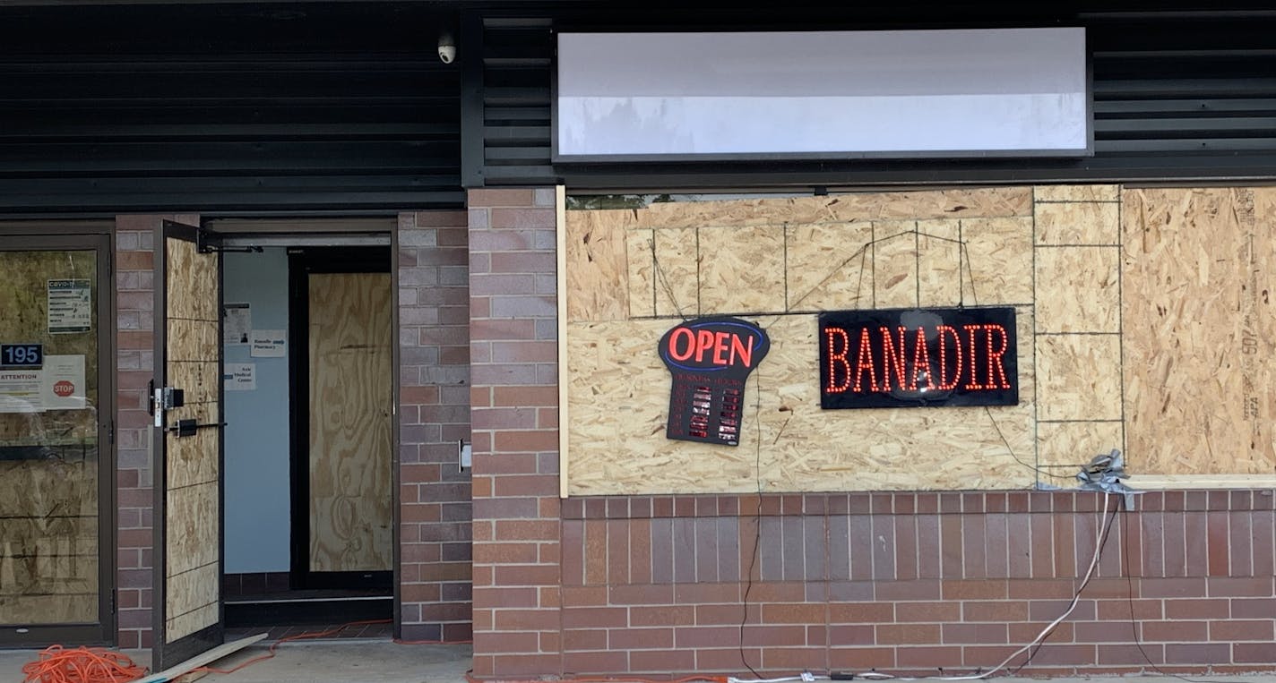 Banadir Pharmacy on West Lake Street in south Minneapolis reopened on Monday even though it remained boarded up.