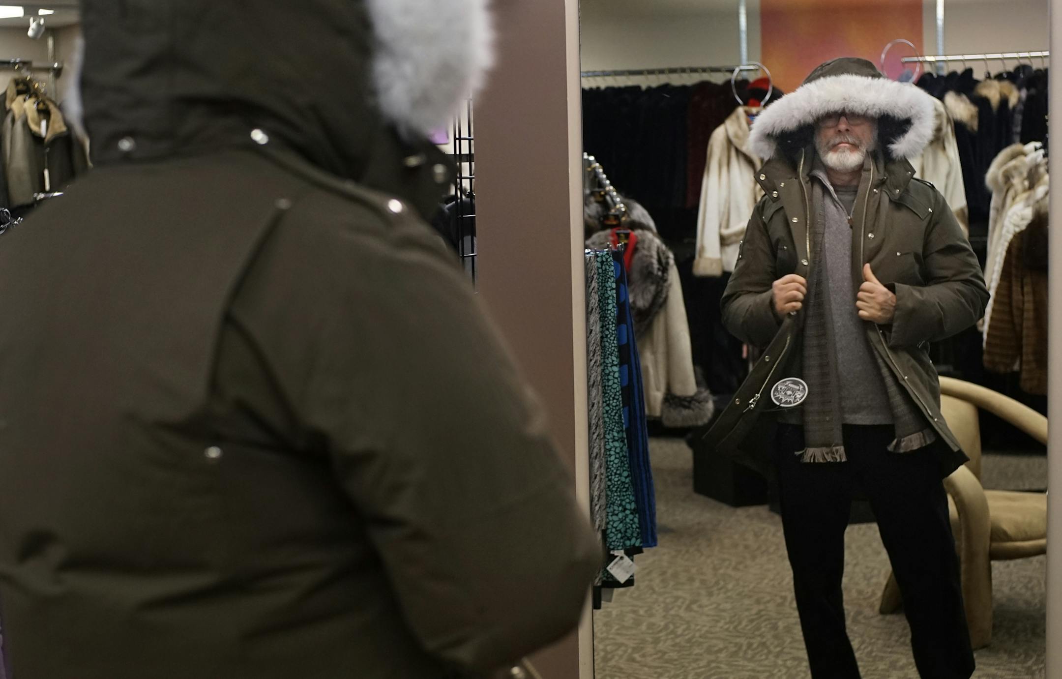 At Ribnick Furs and Leather, John Hampton of Minneapolis tried out a fur-lined parka. An unseasonably warm and relatively snow-free holiday season has many retailers and apparel makers in Minnesota feeling Scrooged this season. Sales of winter coats, gloves, scarves and boots have plunged.] Richard Tsong-Taatarii/rtsong-taatarii@startribune.com