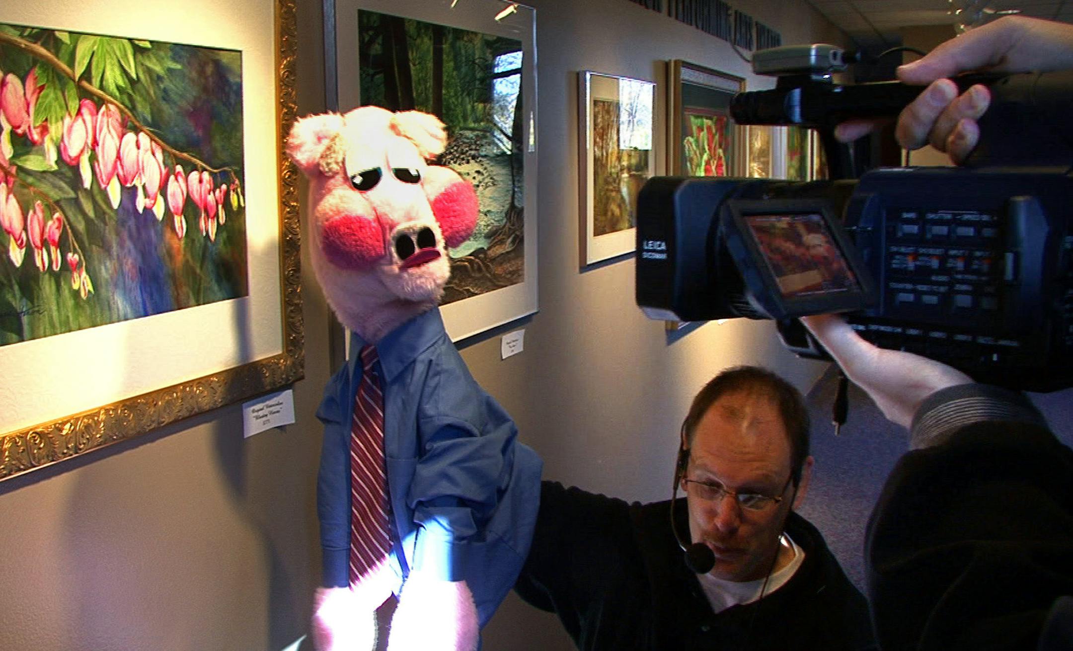 Jim Schiffman acted as Hank the Hog as he filmed a skit at the Lakeville Arts Center with Tim Klausler doing the camera work Monday. Both men are video production specialists with Lakeville Kids & Government, a children�s show that takes an educational and humorous look at government. The show is nominated for an Upper Midwest Regional Emmy Award in the Children/Youth program category for the second time.