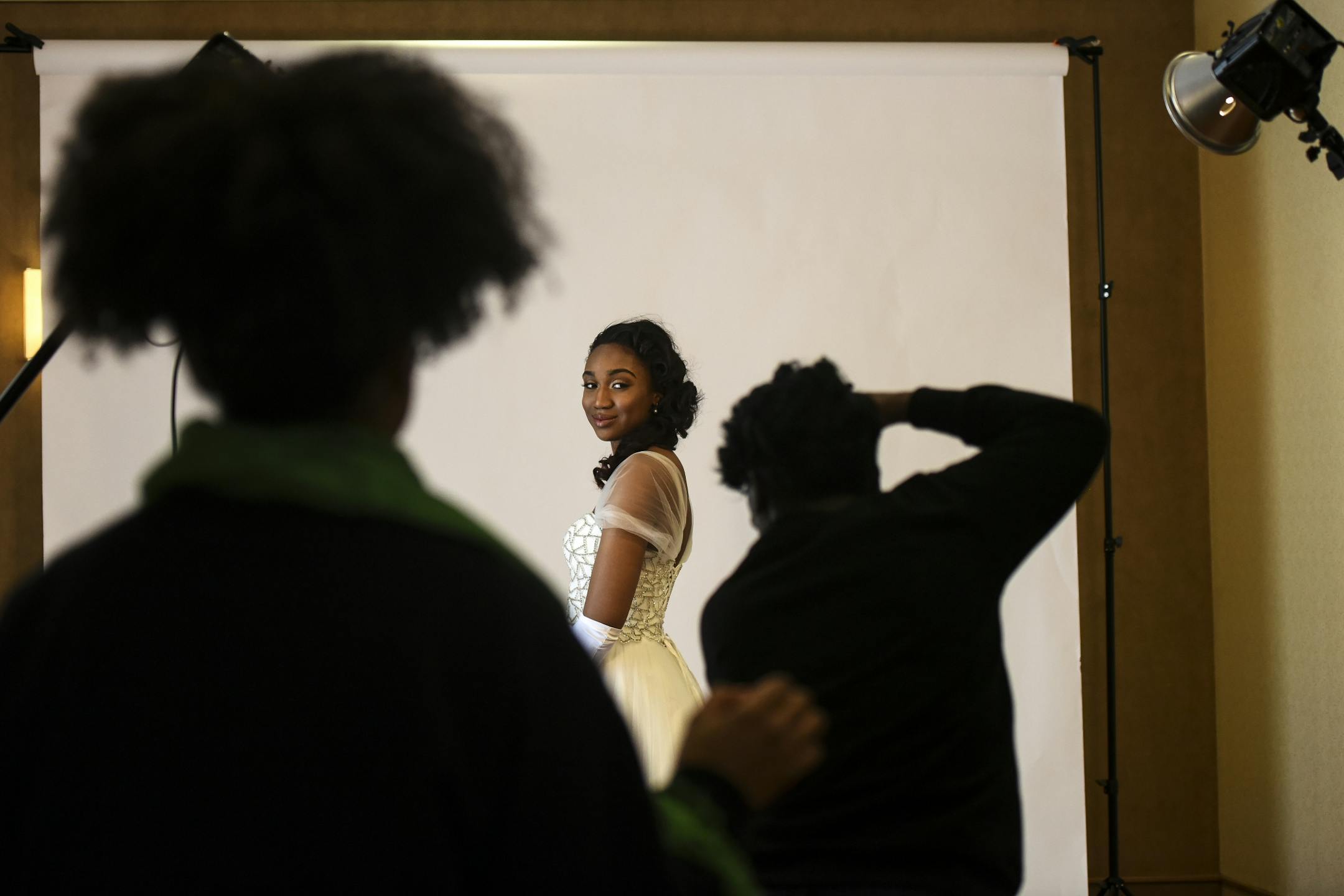 Photographer Nagashia Jackson, bottom right, of Minneapolis, took studio portraits of debutante Jadyn Hayes, a senior at Totino Grace, a few hours before the start of Saturday's cotillion.