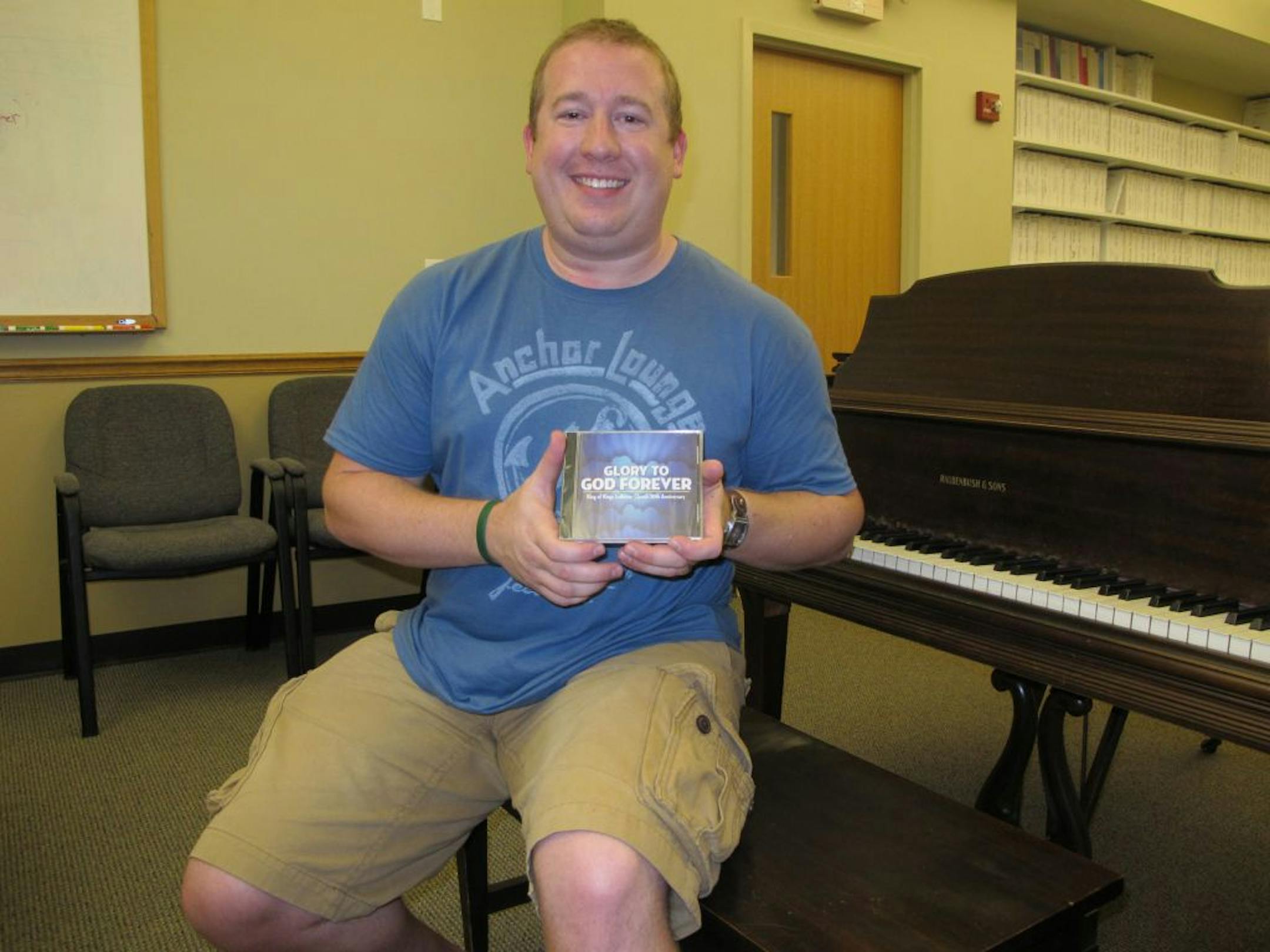 Worship Director Chris Vorrie holds a copy of Glory to God Forever�