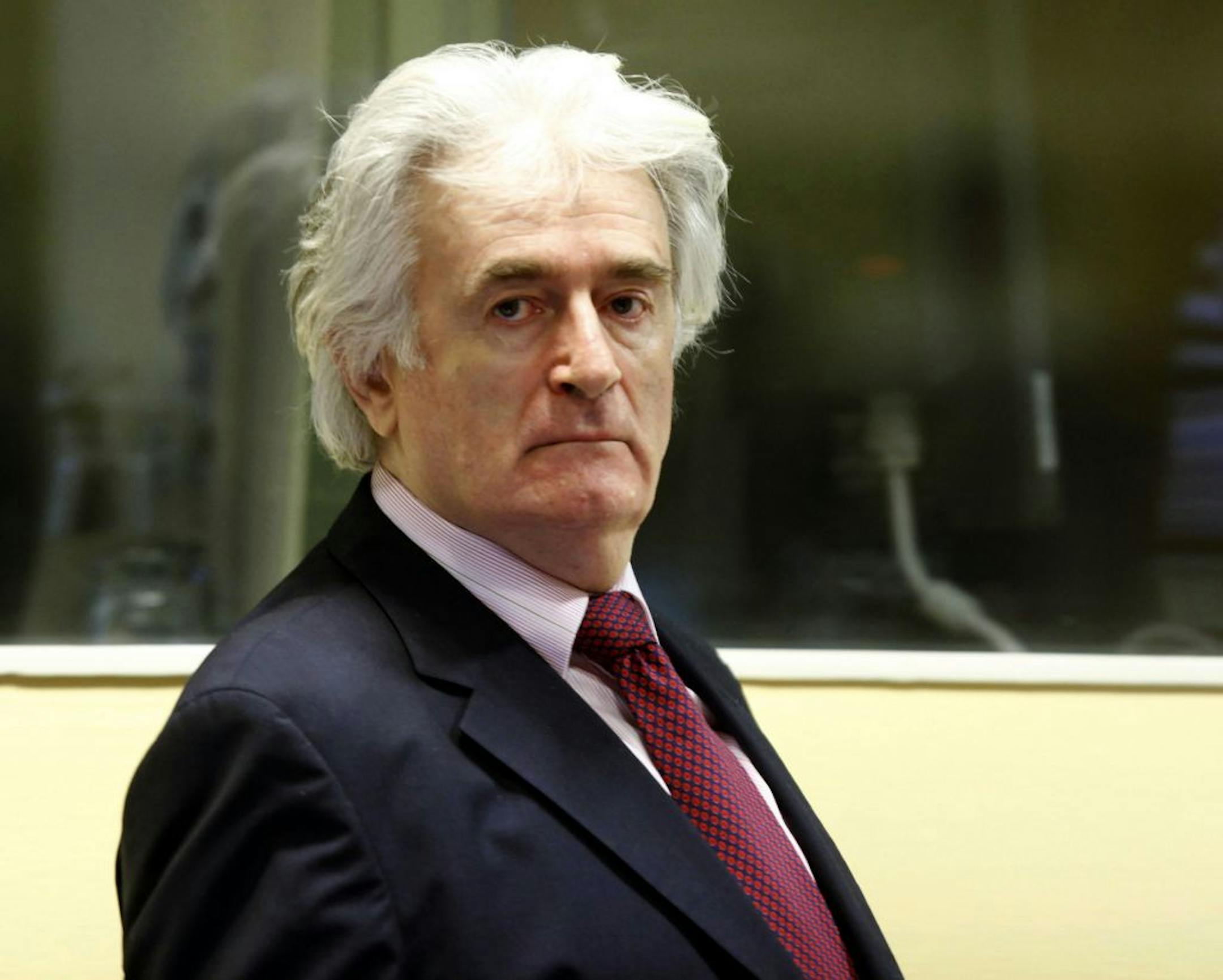 FILE - In this Nov. 3, 2009 file photo former Bosnian Serb leader Radovan Karadzic enters the courtroom of the U.N.'s Yugoslav war crimes tribunal (ICTY) in The Hague, Netherlands. The ICTY has acquitted Karadzic of one of the two genocide charges he faces at the halfway stage of his long-running trial on Thursday, June 28, 2012. Judges say prosecutors did not present enough evidence to support the genocide count covering mass killings, expulsions and persecution by Serb forces of Muslims and Cr