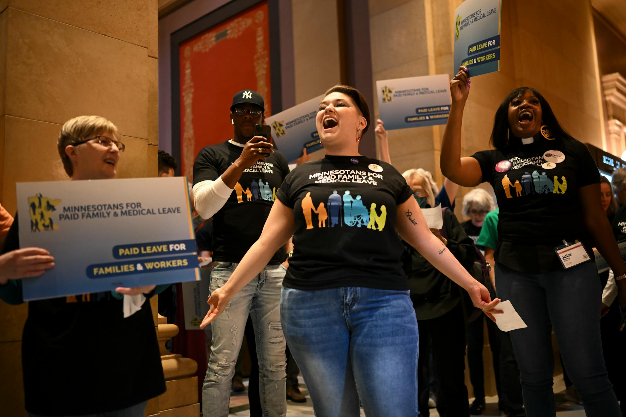 Minnesota AFL-CIO organizer Haylee Hilton leads a rally in support of paid family leave Monday, May 8, 2023, at the Minnesota State Capitol in St. Paul, Minn.. The Senate took up the paid family medical leave bill, which the House already passed. Republicans and some business owners have concerns about the bill, while a coalition supporting the proposal rallied outside the Senate chambers.