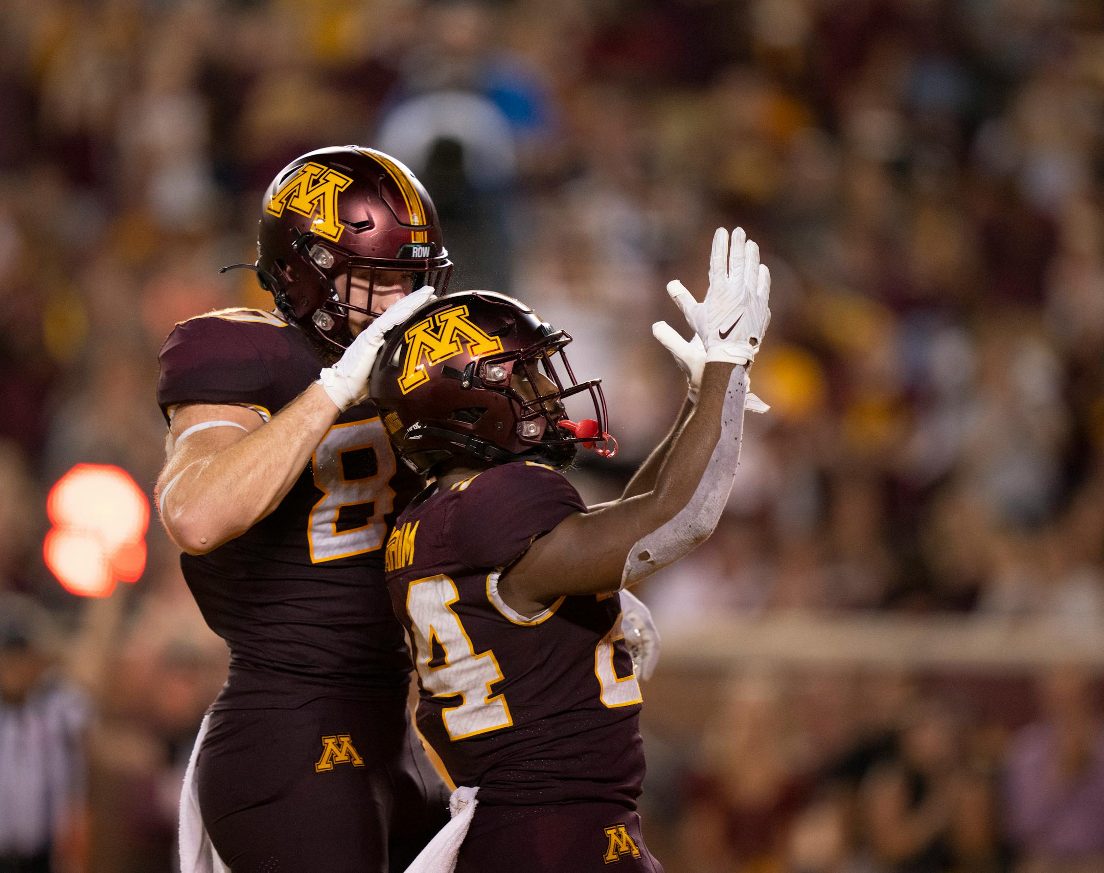 Minnesota Golden Gophers running back Mohamed Ibrahim (24) celebrated his second quarter touchdown from the one yard line with teammate Nick Kallerup (87).