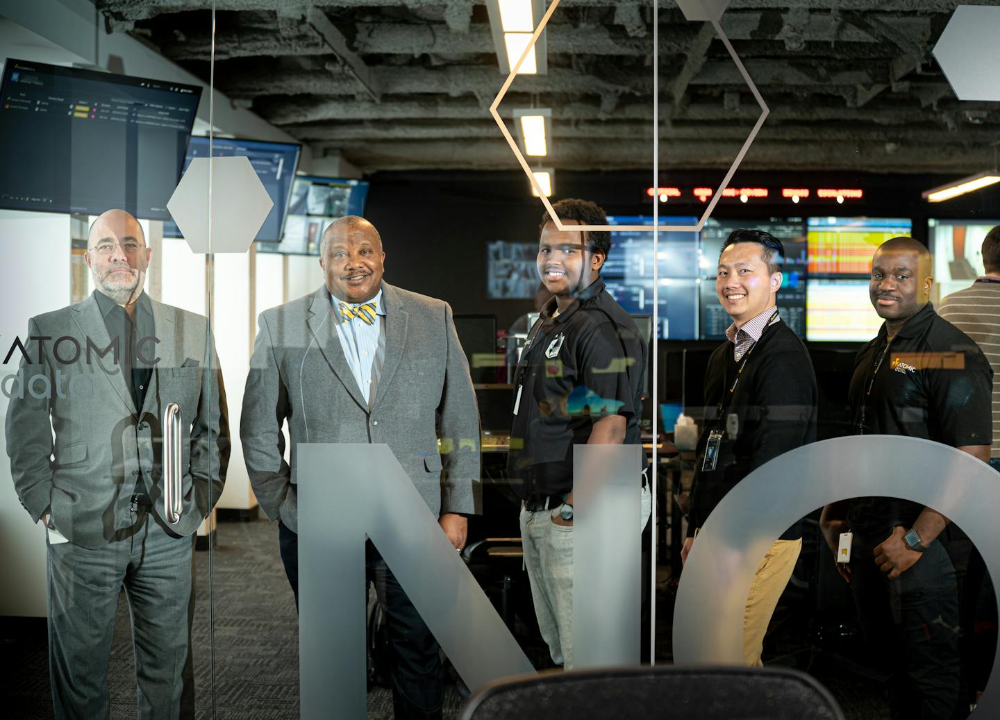 Summit Academy of Minneapolis provides free training that is supported by growing relationships with private employers such as Atomic Data. Jim Wolford, CEO of Atomic Data, and Louis King, CEO of Summit Academy, stood with Summit graduates and Atomic employees Ahmed Omar, Peng Her and Linus Onuoha.