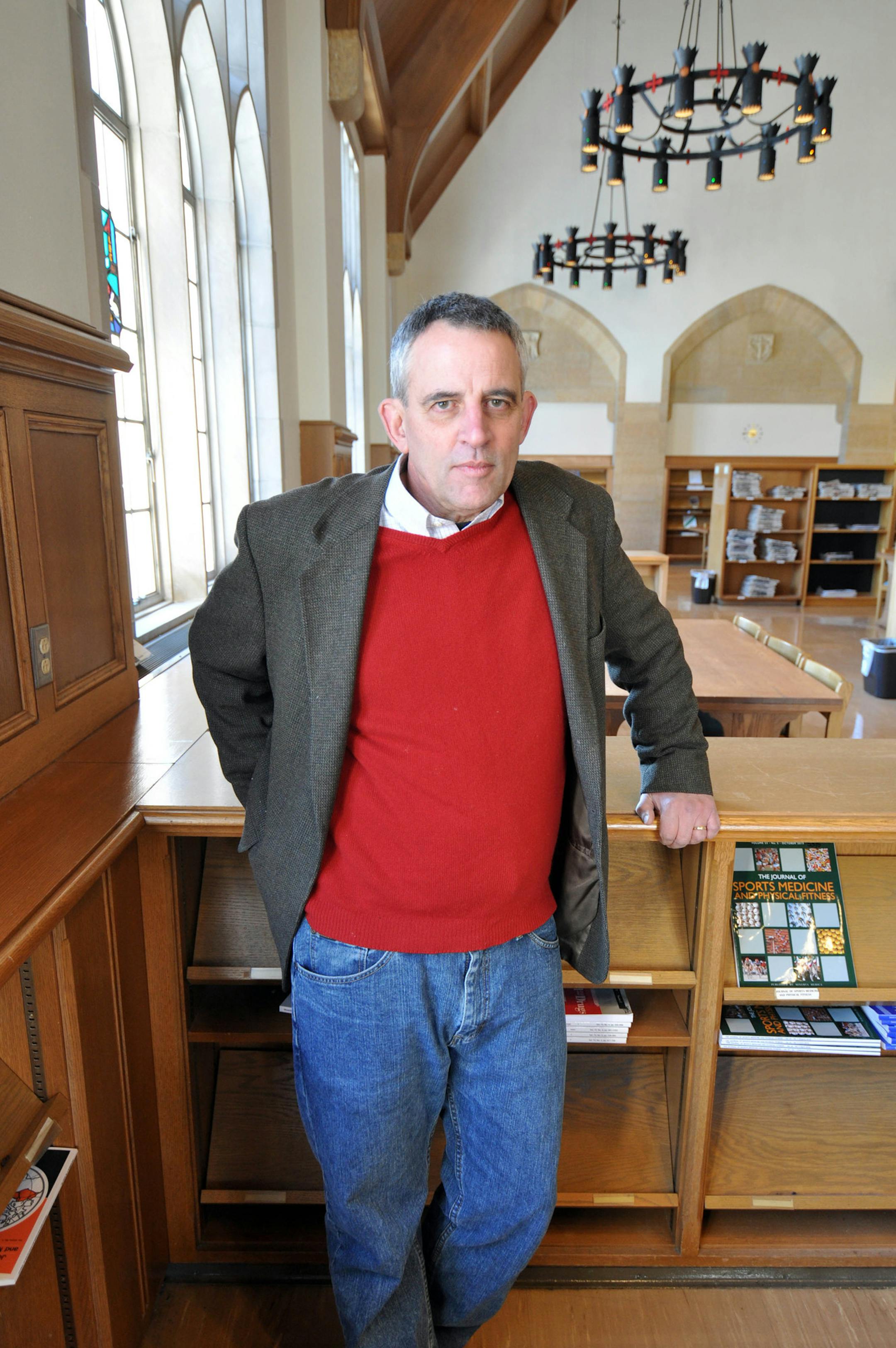 Jim Rogers, pictured here in the University of St. Thomas library, will lead a free two-part session on memoir writing at the South St. Paul Public Library. Rogers likes to quote Wallace Stegner, who once wrote, ìTell me where youíre from, and Iíll tell you who you are.î (Photo by Liz Rolfsmeier)
