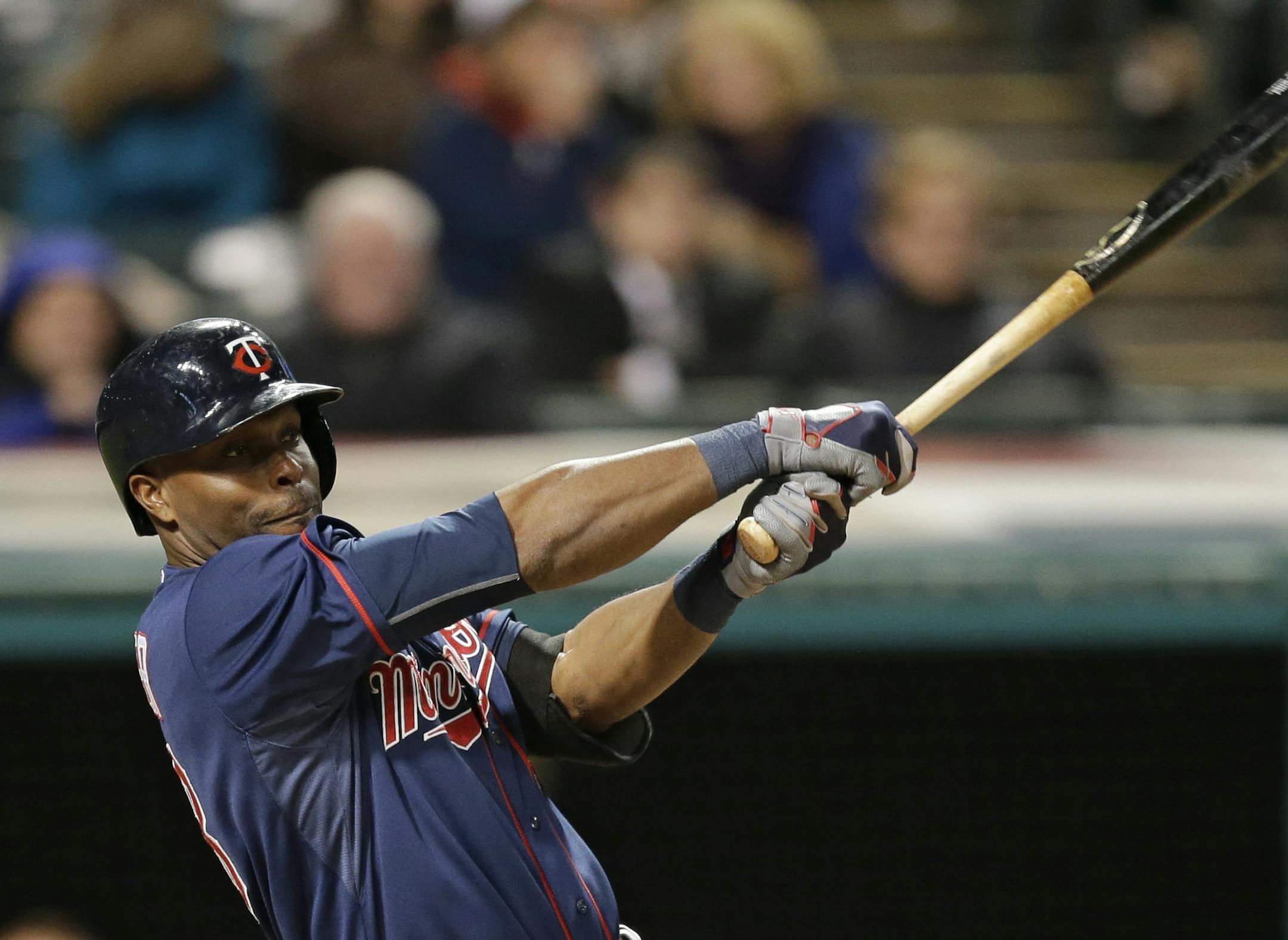 Minnesota Twins' Torii Hunter hits an RBI-sacrifice fly off Cleveland Indians relief pitcher Cody Allen in the ninth inning of a baseball game, Thursday, Oct. 1, 2015, in Cleveland. Eddie Rosario scored on the play. (AP Photo/Tony Dejak)