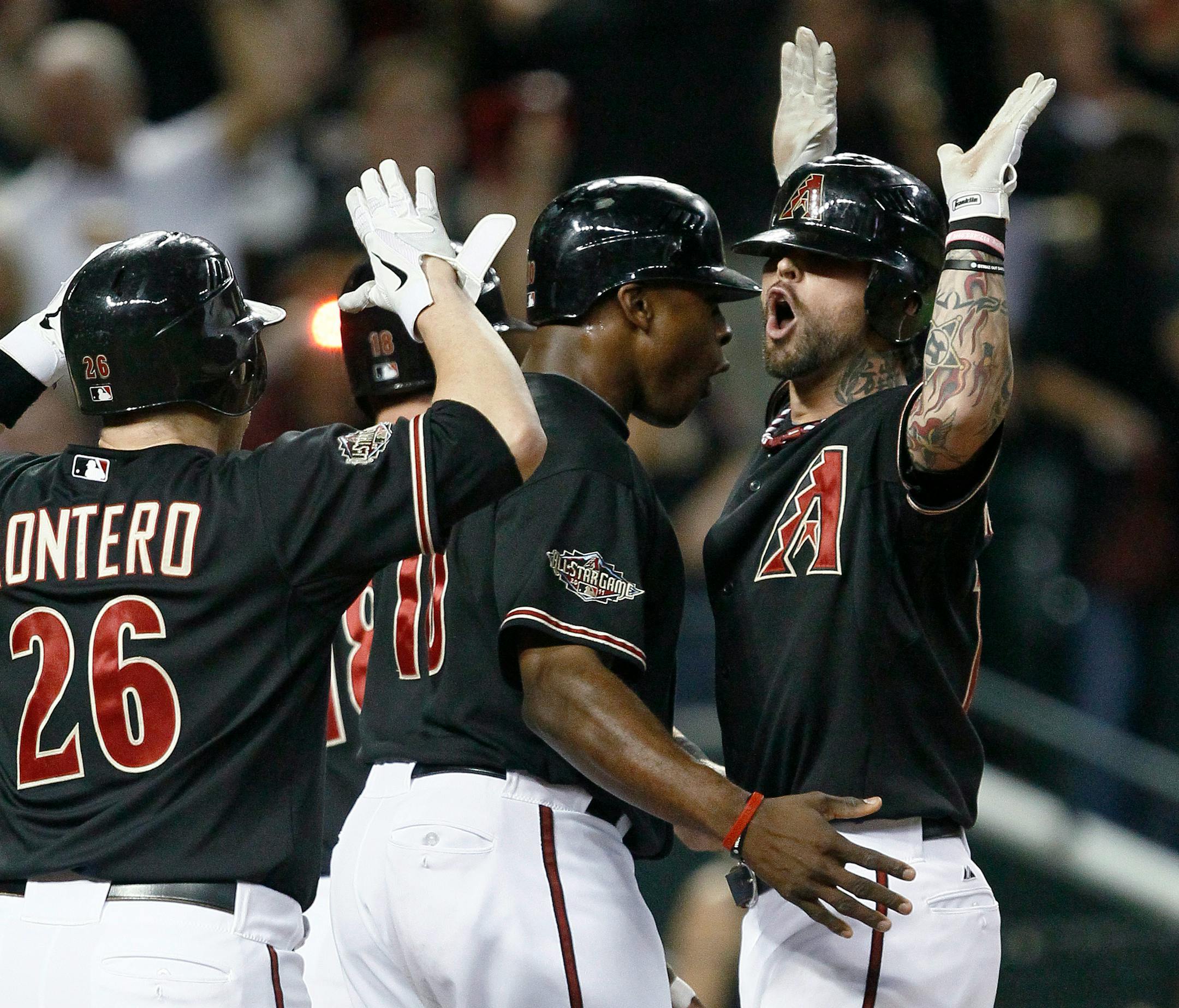 Arizona's Ryan Roberts, right, was greeted at home plate by teammates following his first-inning grand slam against Milwaukee in Game 4 on Wednesday night in Phoenix.