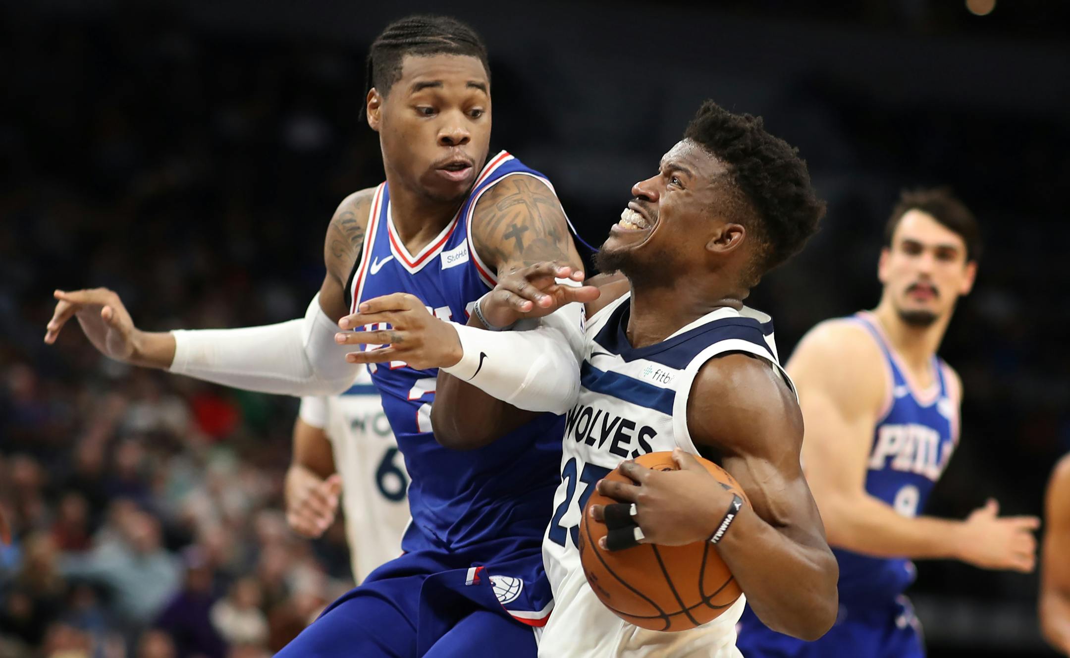 Minnesota Timberwolves guard Jimmy Butler (23) was call and offensive foul as Philadelphia 76ers forward Richaun Holmes (22) played good defense during second half NBA action at Target Center Tuesday December 12, 2017 in Minneapolis, MN.] The Minnesota Timberwolves hosted the Philadelphia 76ers at Target Center. JERRY HOLT � jerry.holt@startribune.com