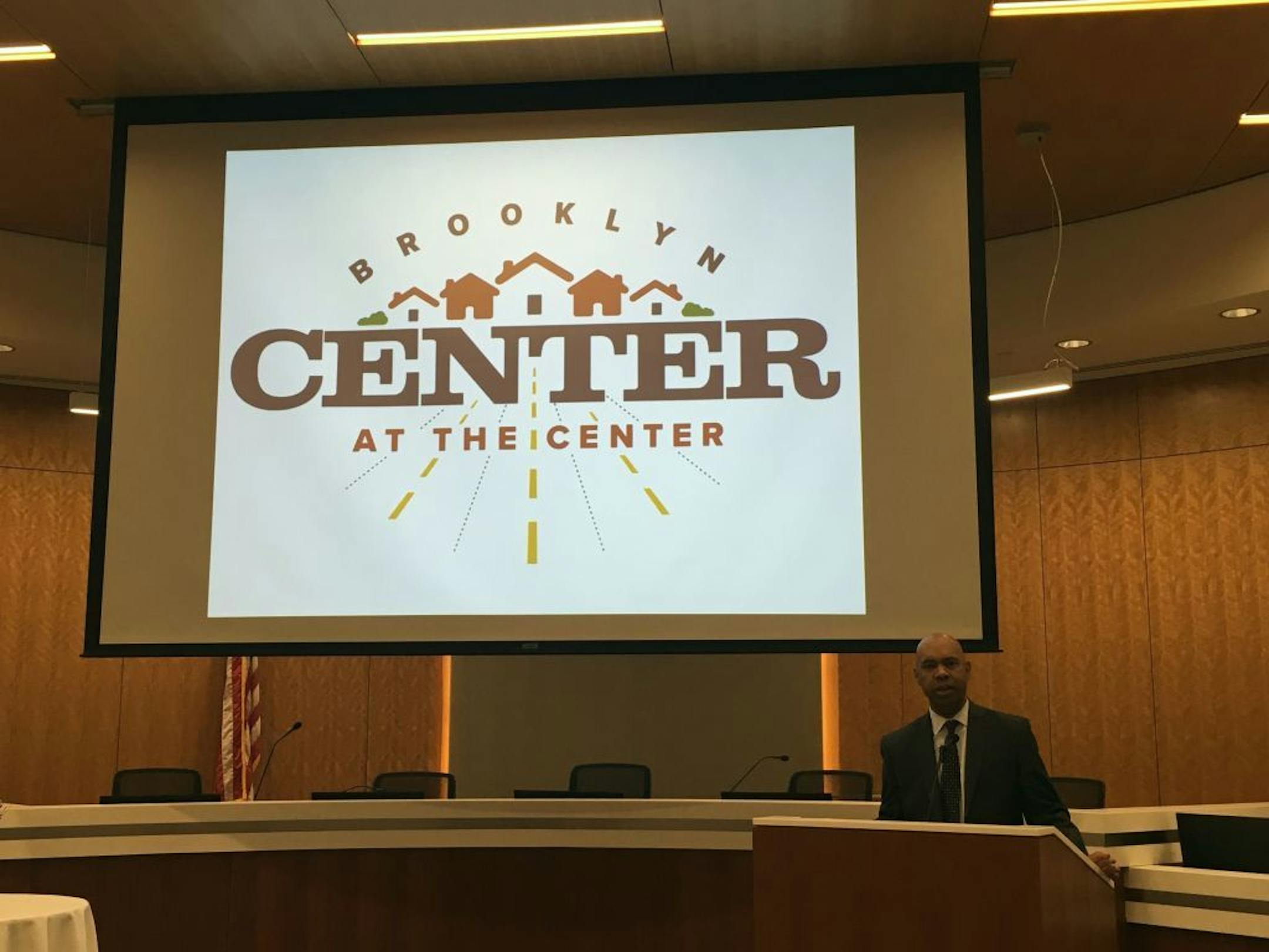 City Manager Curt Boganey and Brooklyn Center's new city logo.