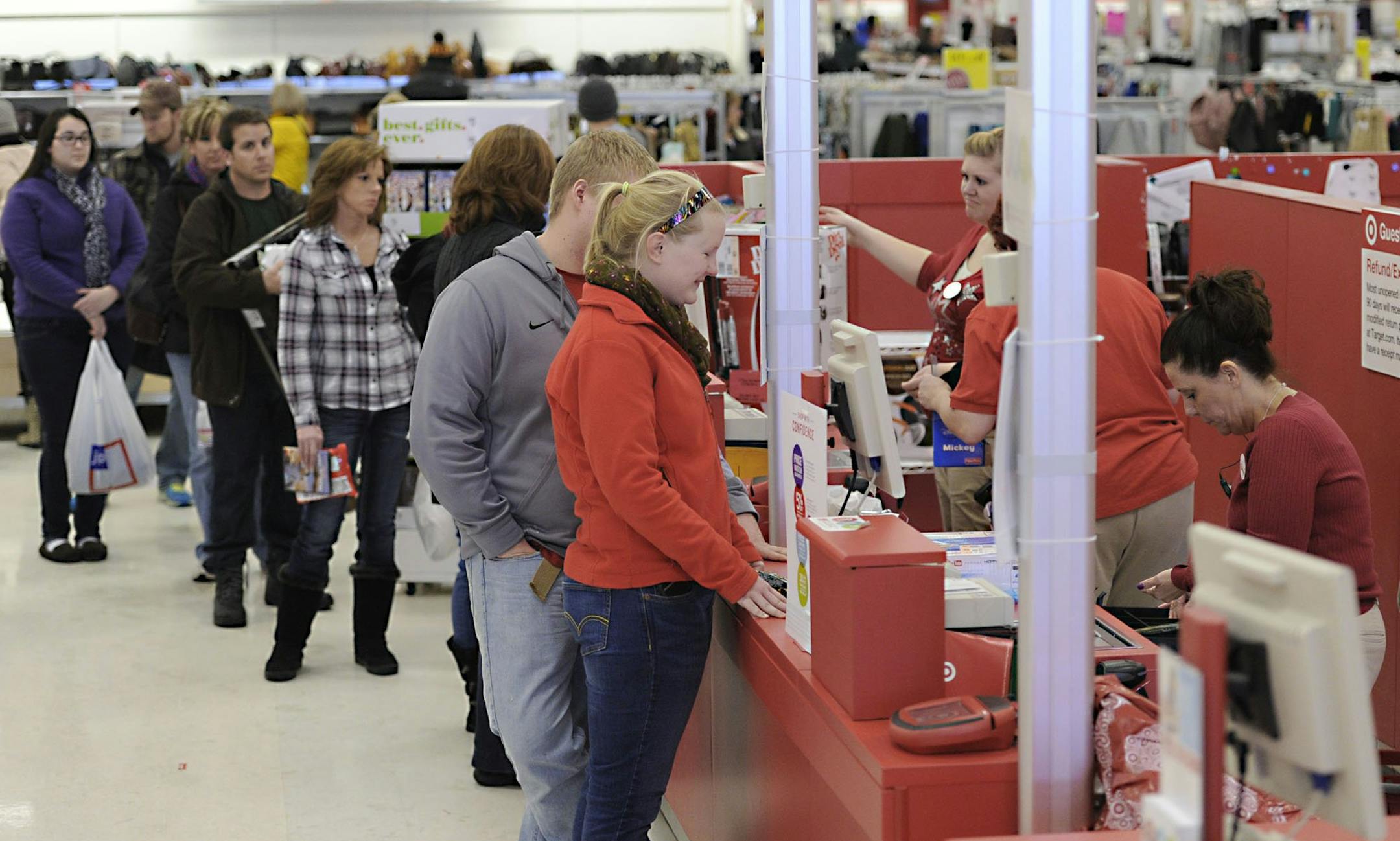 Ally Belden, 21, center, of Greene Township, Erie County, Penn., returns a broken Blu-Ray player at Target in Summit Township, Erie County, Penn. on Dec. 26, 2013. The Target returns line was long at this time, but after-Christmas shopping crowds were mixed at retail stores in the Erie area on Thursday. (AP Photo/Erie Times-News, Christopher Millette)