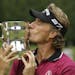 Bernhard Langer, of Germany, kisses the U.S. Senior Open golf tournament trophy Sunday, Aug. 1, 2010, at Sahalee Country Club in Sammamish, Wash.