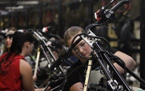 Arctic Cat line workers assemble Arctic Cat XF 8-00 snowmobiles at Arctic Cat's muanufacturing facility Wednesday, May 15, 2013 in Thief River Falls,