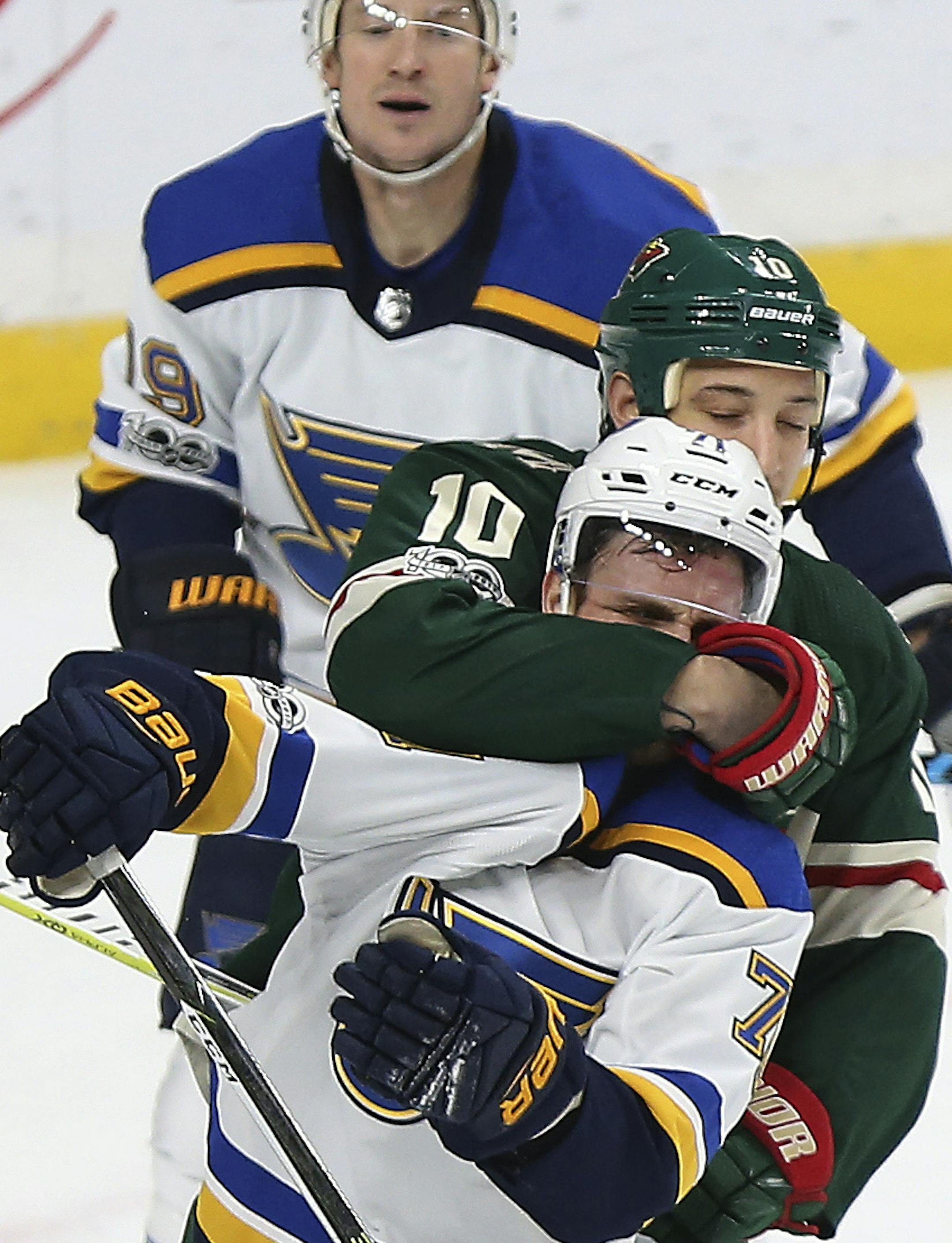 Minnesota Wild's Chris Stewart (10) grabs St. Louis Blues' Vladimir Sobotka (71) during the first period of an NHL hockey game Saturday, Dec. 2, 2017, in St. Paul, Minn. (AP Photo/Stacy Bengs)