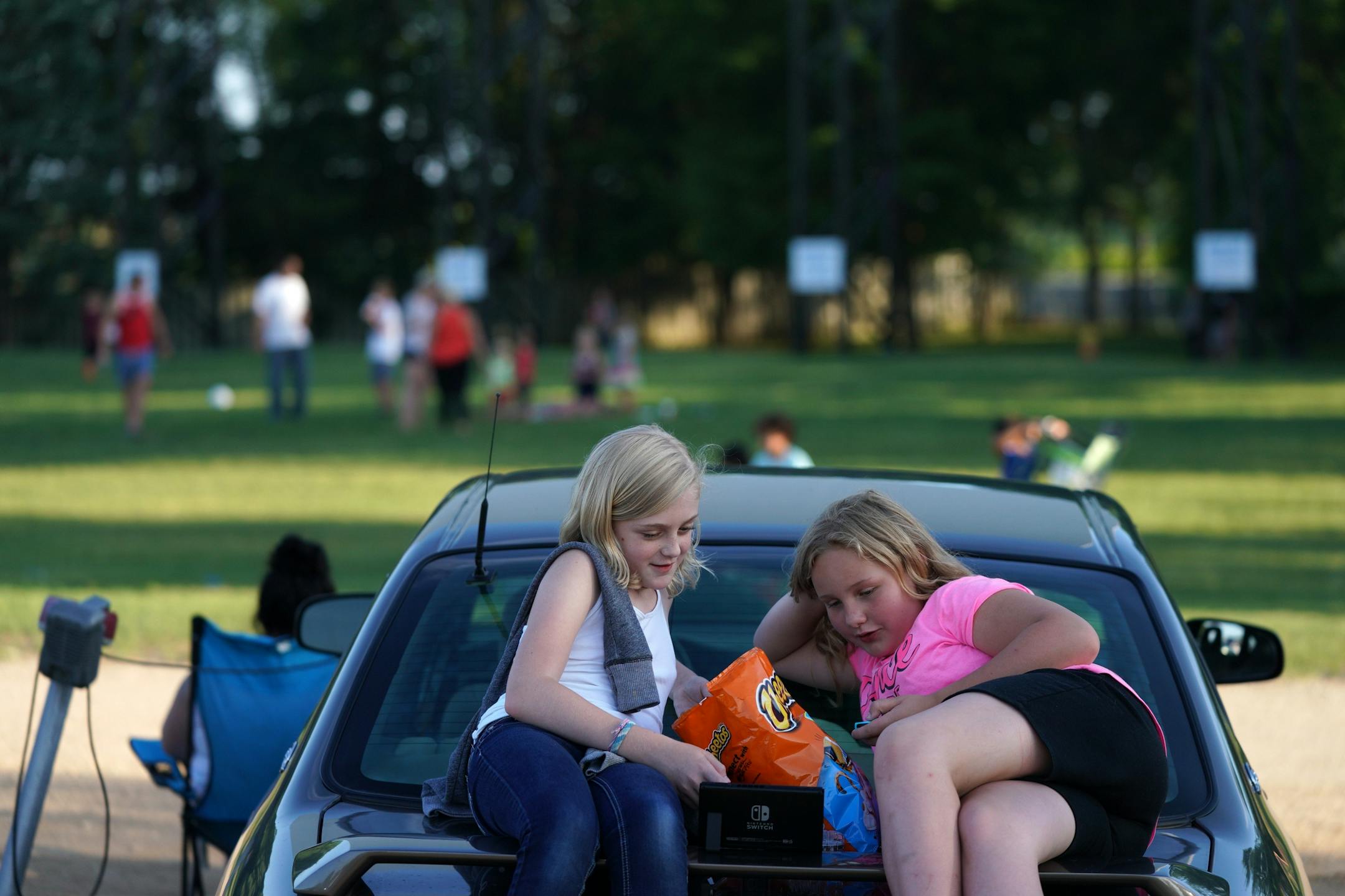 Madison Buelow and Annika Ostrowski, both 11, of White Bear Lake watched a movie on their tablet as they waited for the start of Friday night's show.