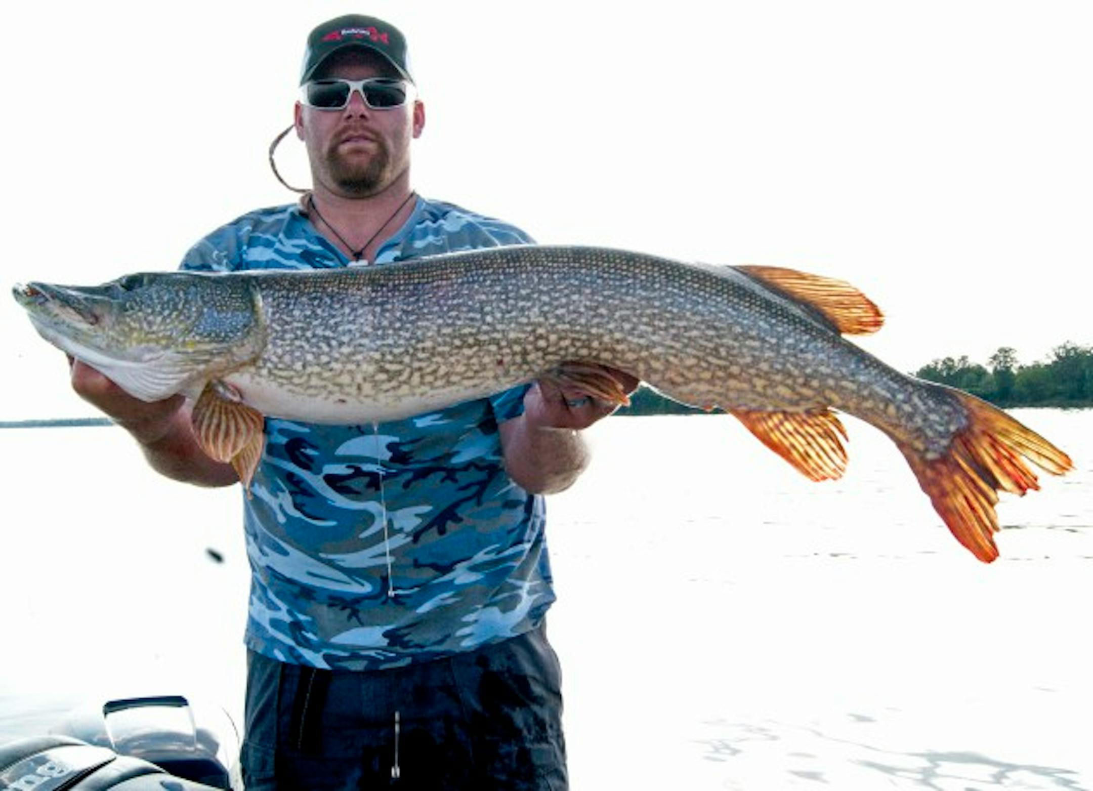 Travis Hultgren and a giant northern pike caught in Lake Mille Lacs.