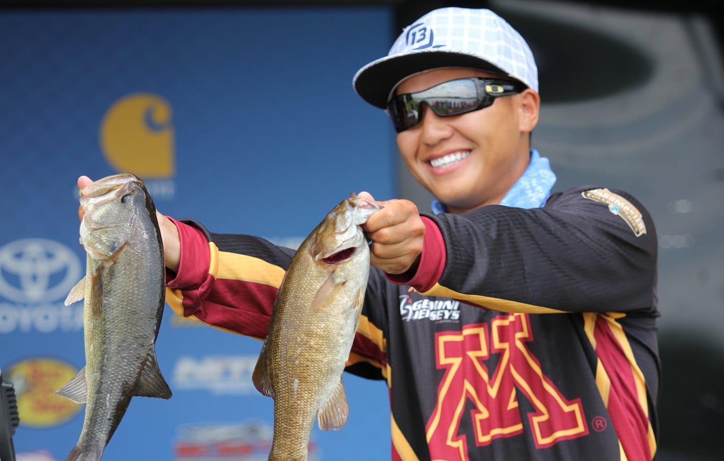 University of Minnesota student Trevor Lo with the two fish that helped him win the National B.A.S.S. Bass Fishing Championship on Tuesday near Stevens Point, Wis. Lo and othe anglers on the U squad finished second in the national team championships.