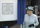 Britain's Queen Elizabeth II unveils a plaque at Runnymede, England, during a commemoration ceremony Monday June 15, 2015, to celebrate the 800th anni