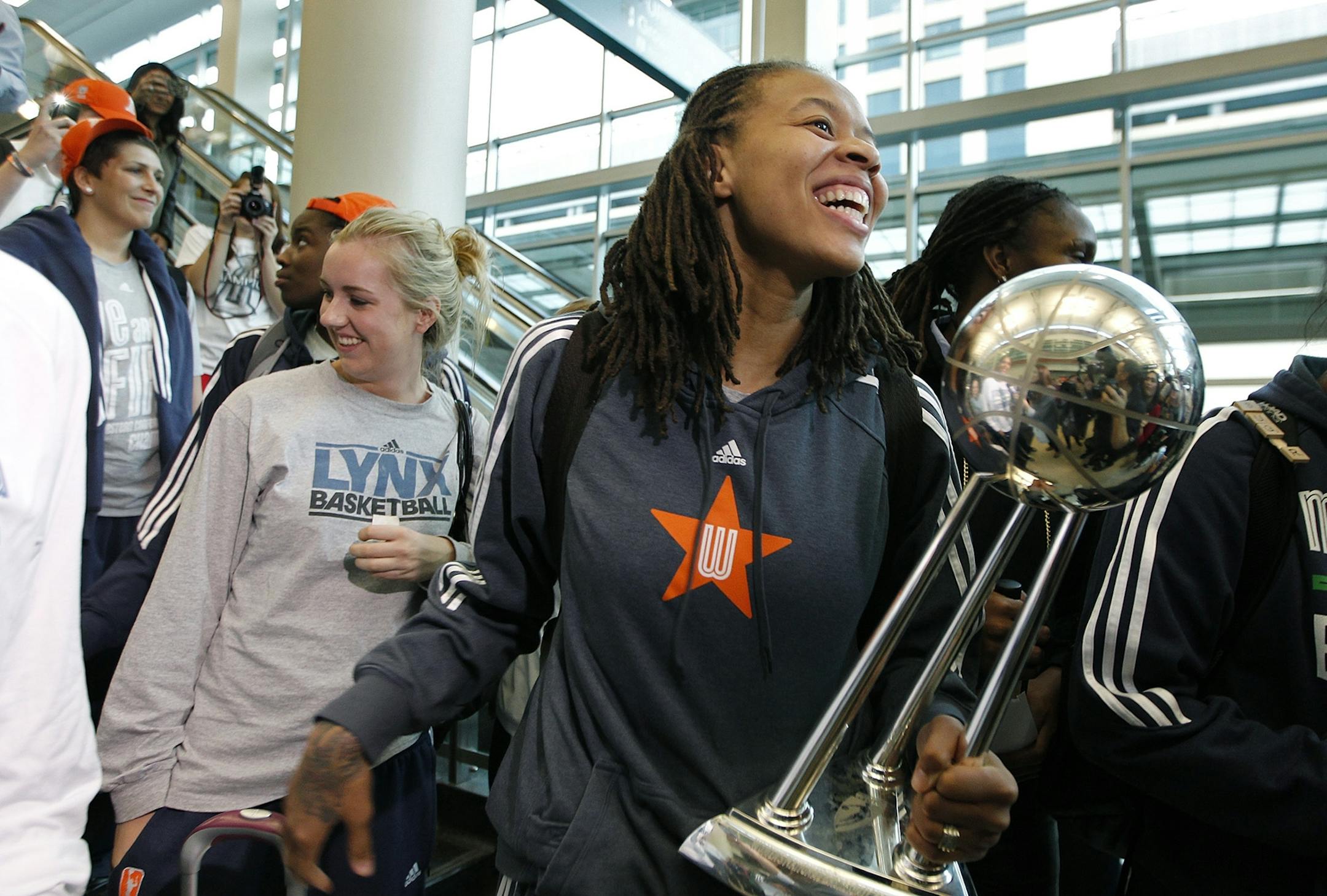 Carrying the Championship trophy, Minnesota Lynx Seimone Augustus and the team were welcomed by fans upon their arrival at the Humphrey Terminal, Friday, October 11, 2012 in Bloomington, MN.
