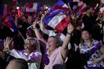 Supporters of French far right leader Marine Le Pen react after the release of projections based on the actual vote count in select constituencies , S