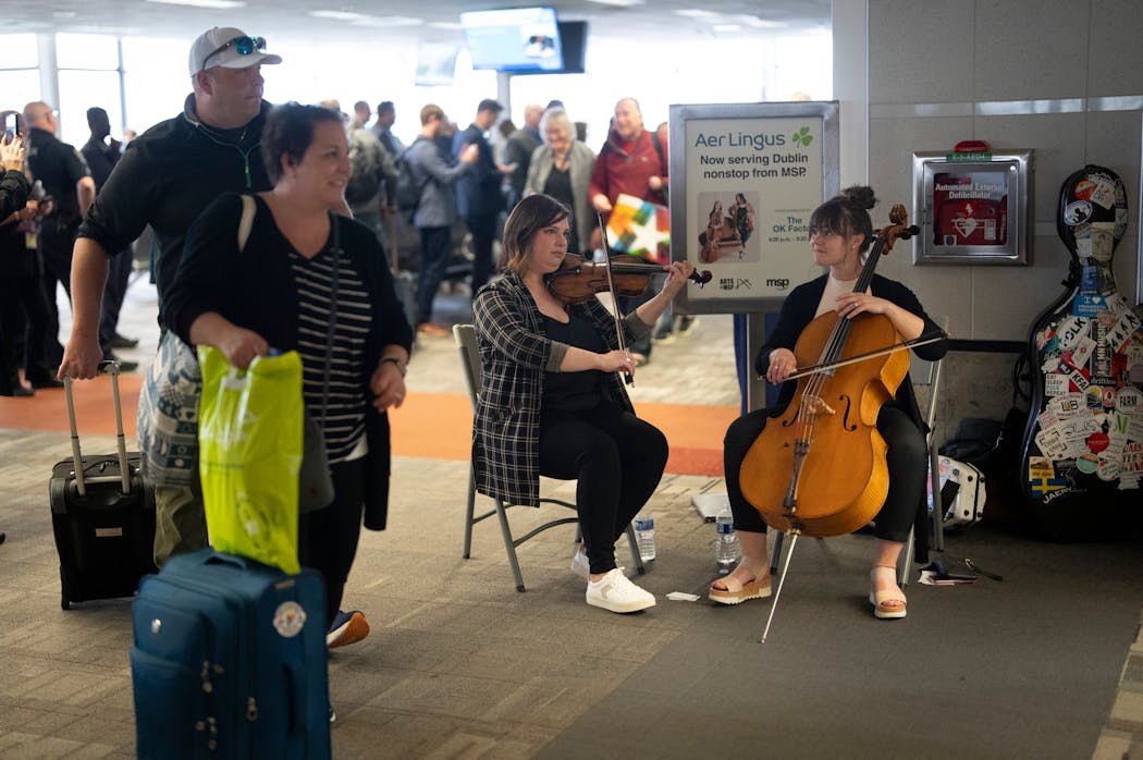 Karla Colahan and Olivia Diercks of the duo the Ok Factor play Irish music as people deboard the first Aer Lingus flight from Dublin, Ireland, on Monday at Minneapolis-St. Paul International Airport's Terminal 1. To celebrate the occasion, Irish dancing, music and a water cannon salute welcomed the first flight from Dublin.