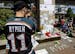 Tyler Stychyshyn wears a Manitoba Moose jersey as he pauses at a makeshift memorial for former Vancouver Canucks hockey player Rick Rypien as fans gat