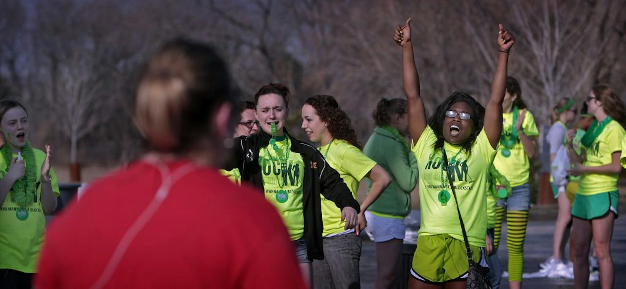 About 40 youths gathered to hand out water to runners at the the Rock Your Block event in Minneapolis, and to encourage participants as they passed by. (girl with raised arms is Erica Kesseh, Burnsville).