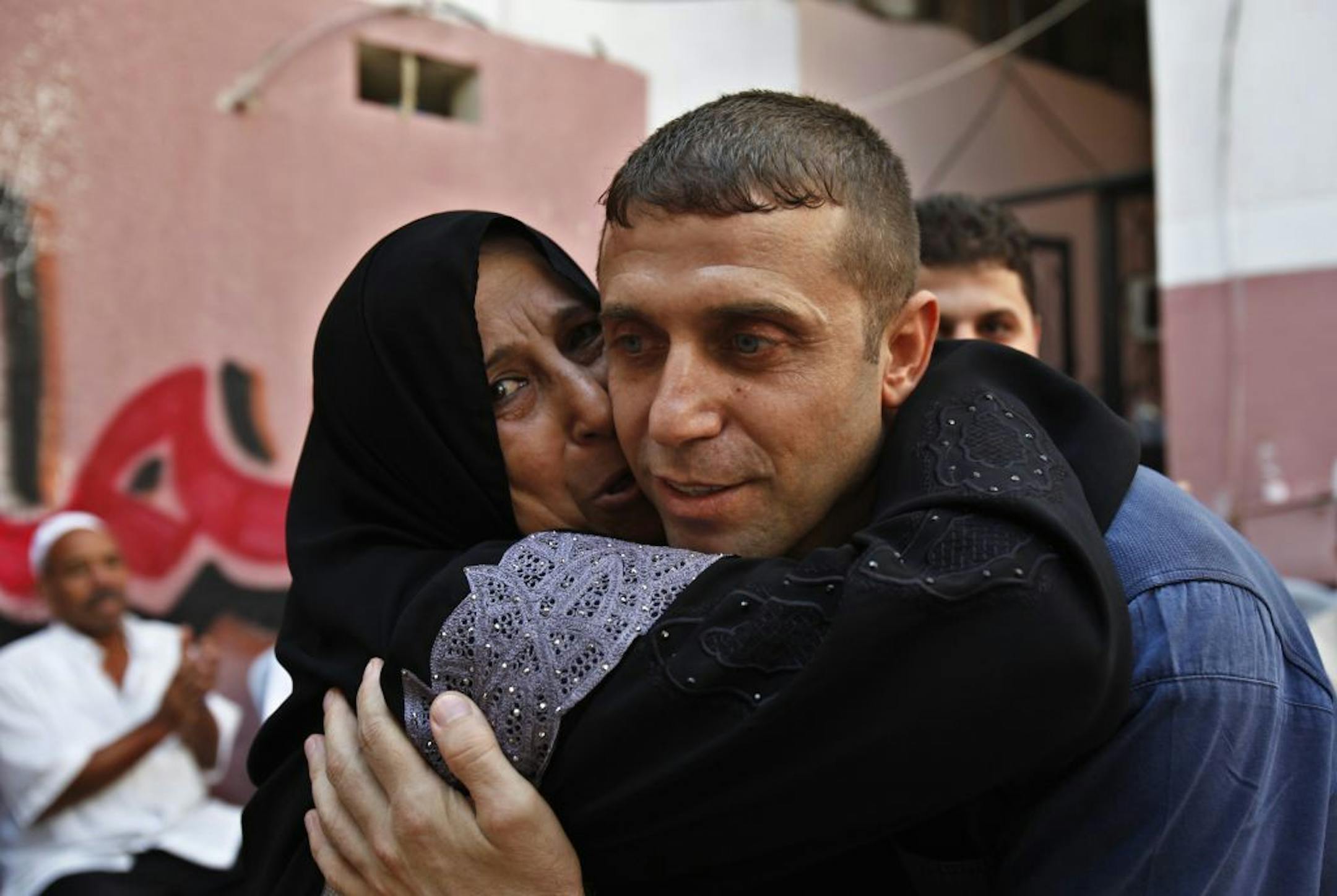Released Palestinian prisoner, Nehad Jondiya, hugs his sister Um rami, after 24 years spent at Israeli jail, at his family house in Gaza City, Wednesday, Aug. 14, 2013.