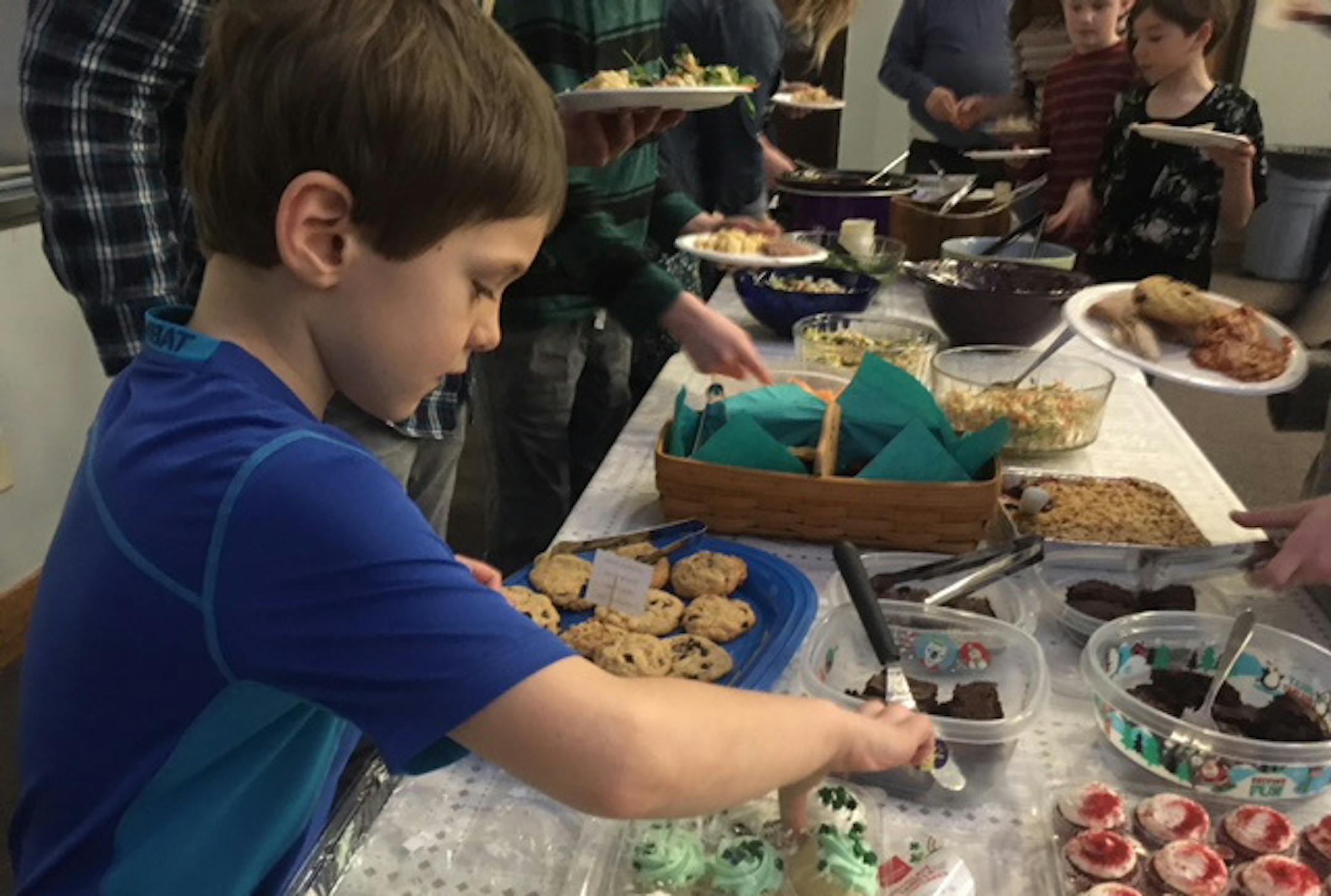 Andy Heil  grabs some dessert at "Breaking Bread'', an alternative religious service at Shepherd of the Valley Lutheran Church
Photo by Jean Hopfensperger.